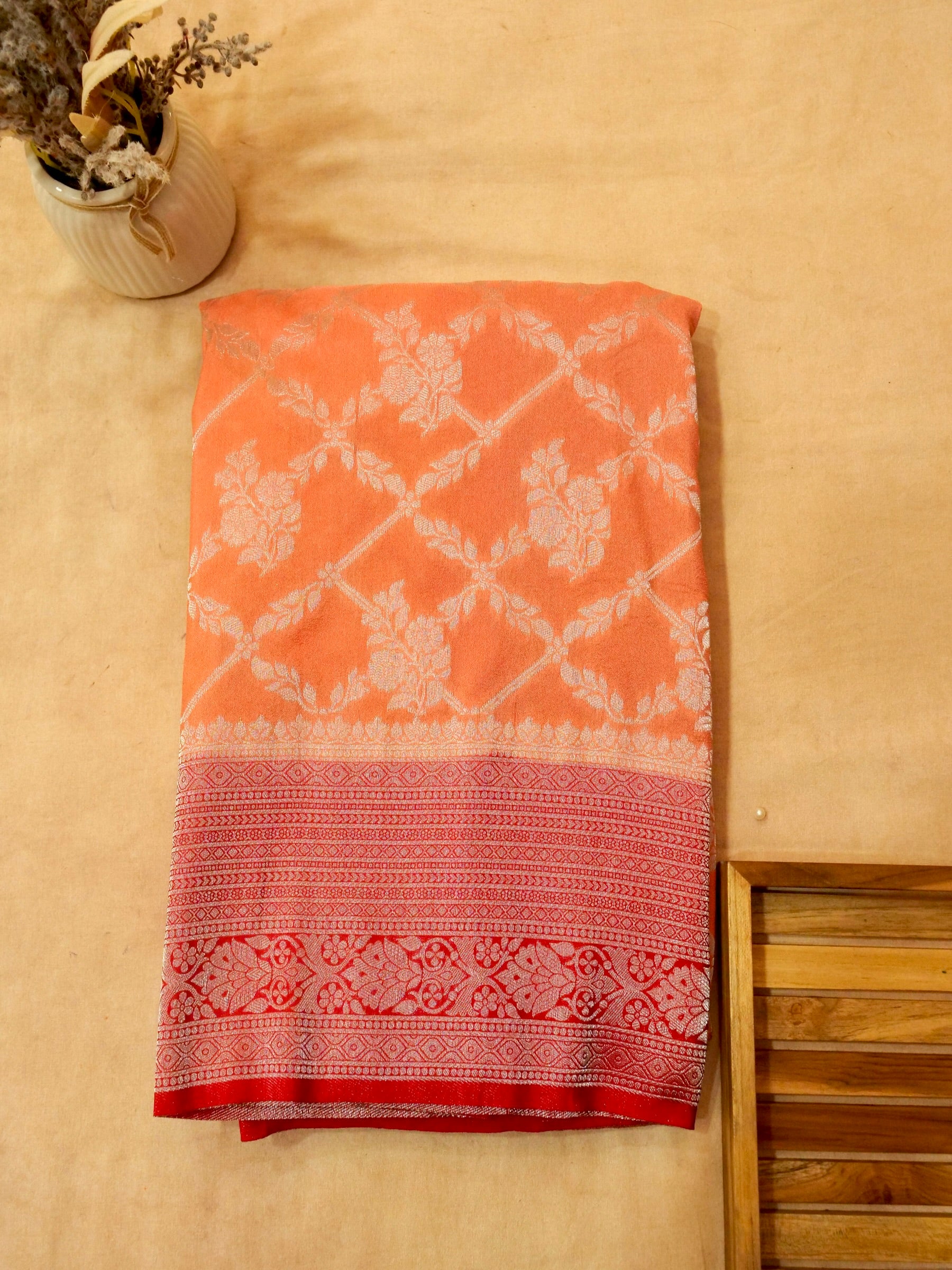 Pastel Orange Crepe Georgette Silk Saree with Red Border