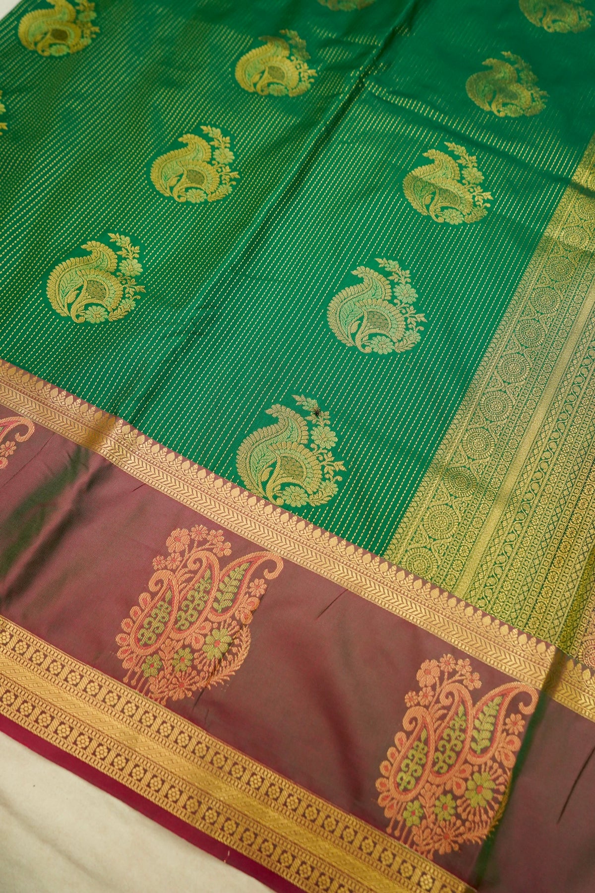 Devyani - Emerald Green Kanjivaram Silk Saree with Mauve Korvai Border