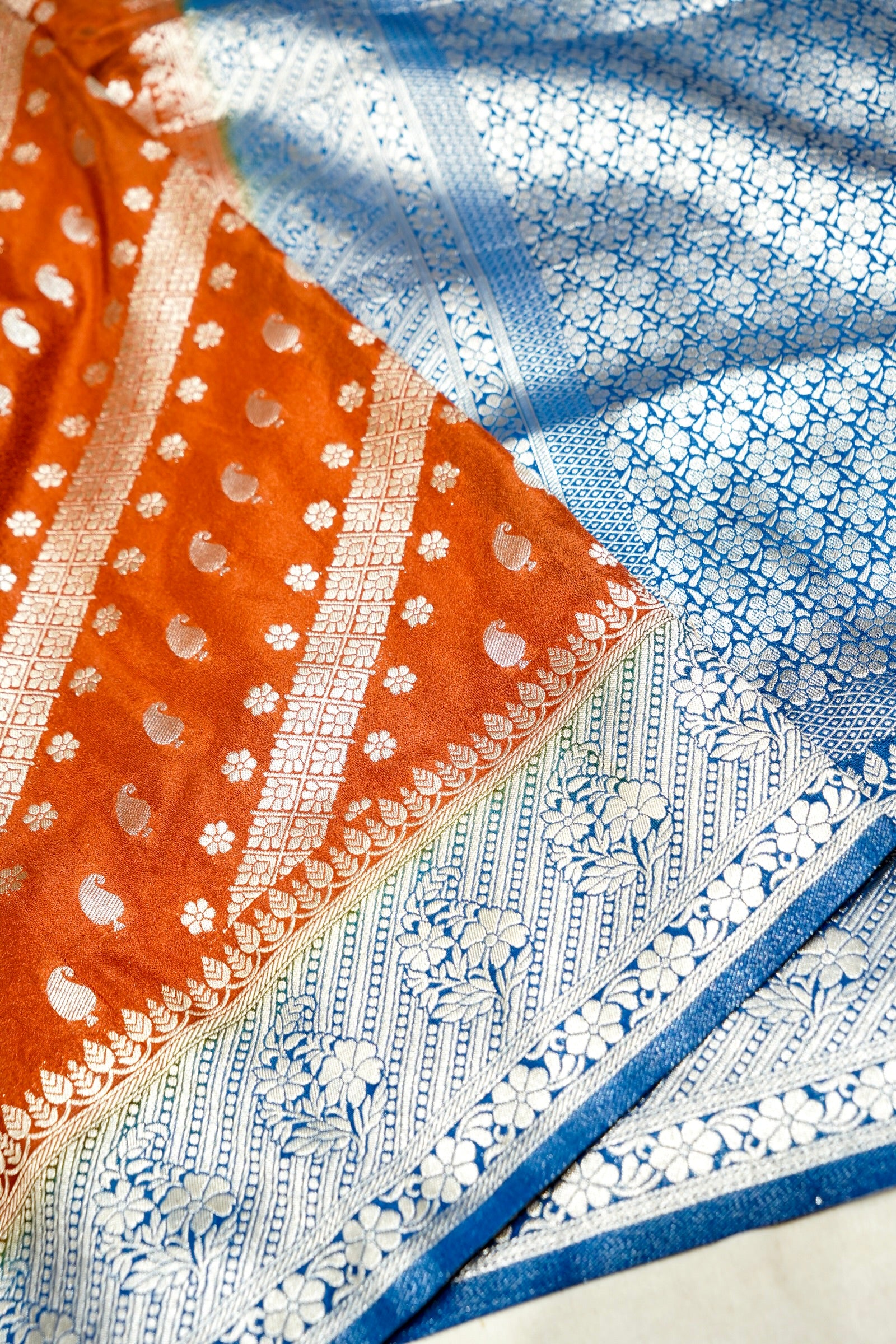 Rust Orange Paisley Crepe Georgette Silk Saree with Cobalt Blue Border