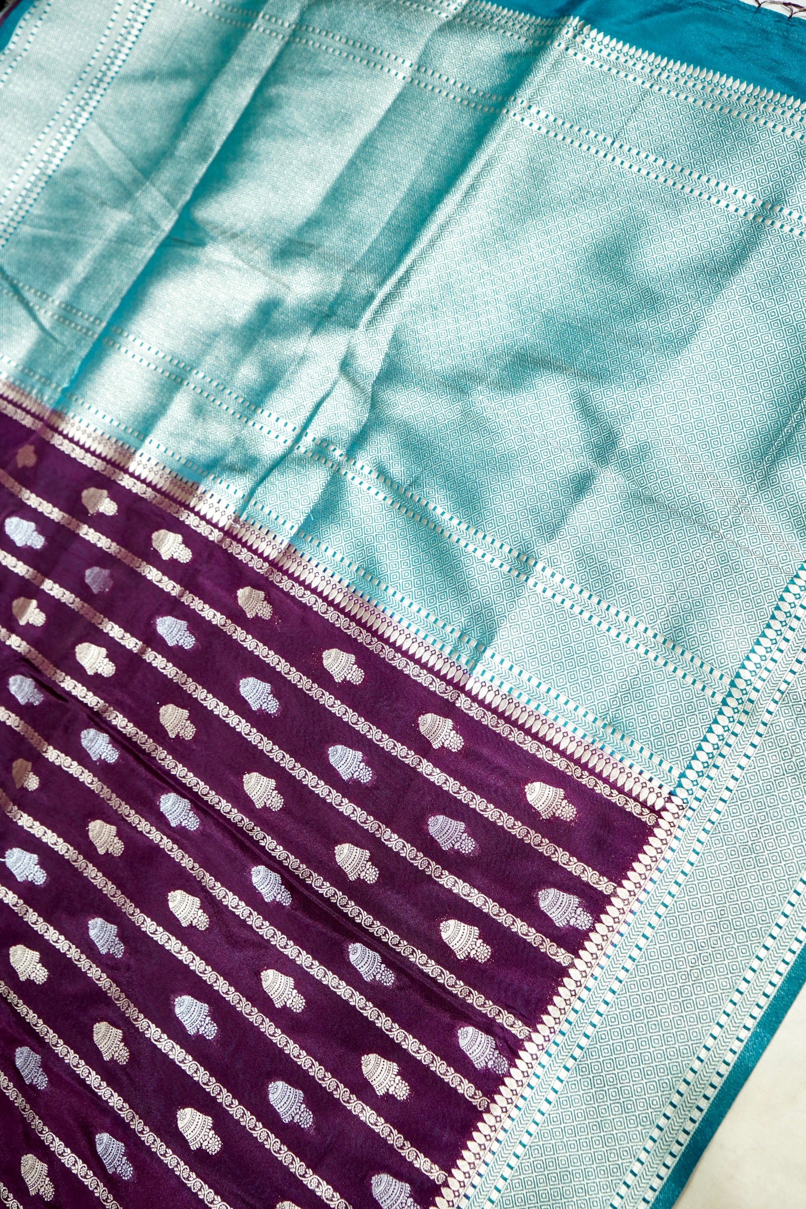 Wine Purple Bell Motifs Crepe Georgette Silk Saree with Teal Border