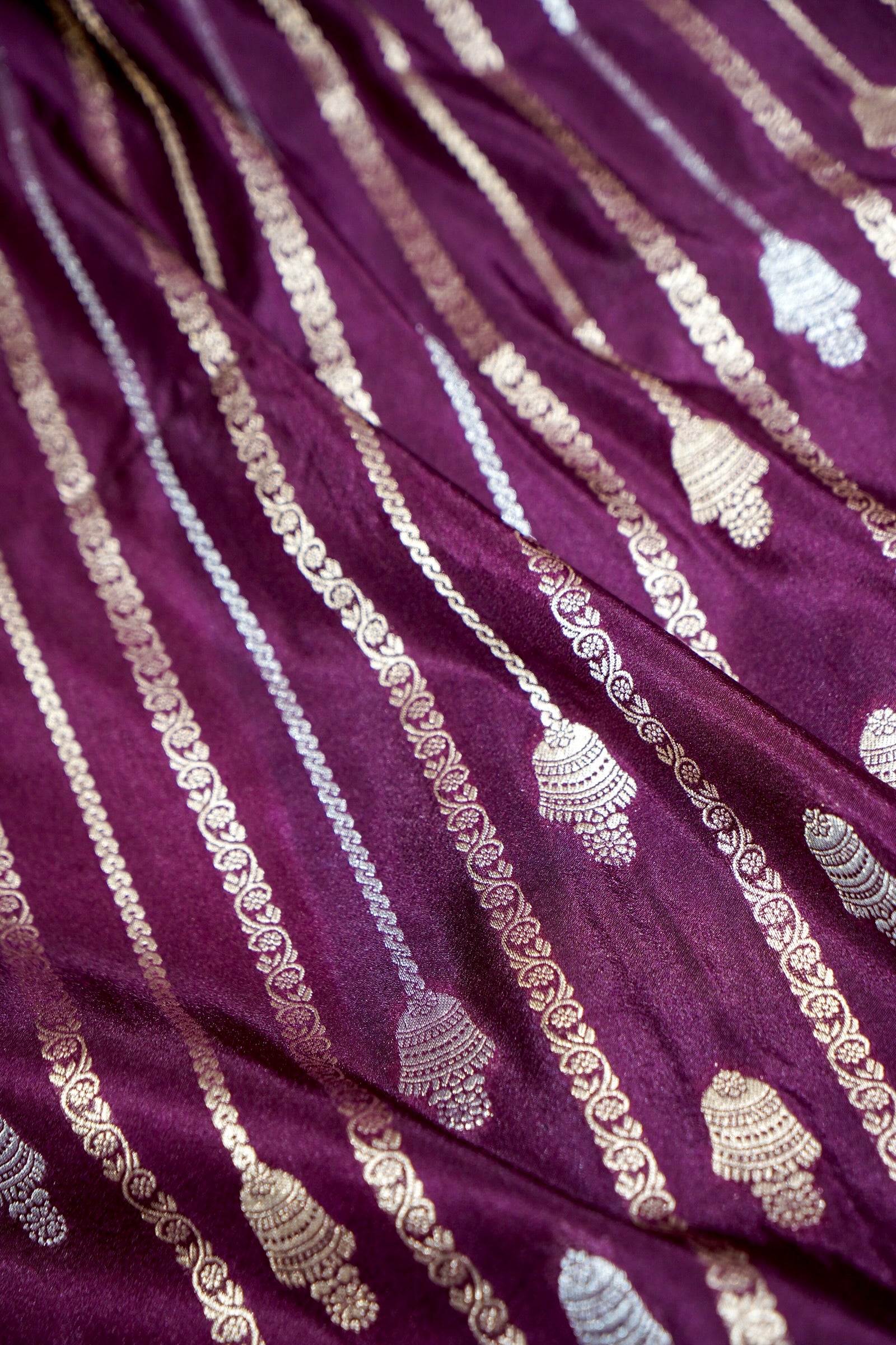 Wine Purple Bell Motifs Crepe Georgette Silk Saree with Teal Border