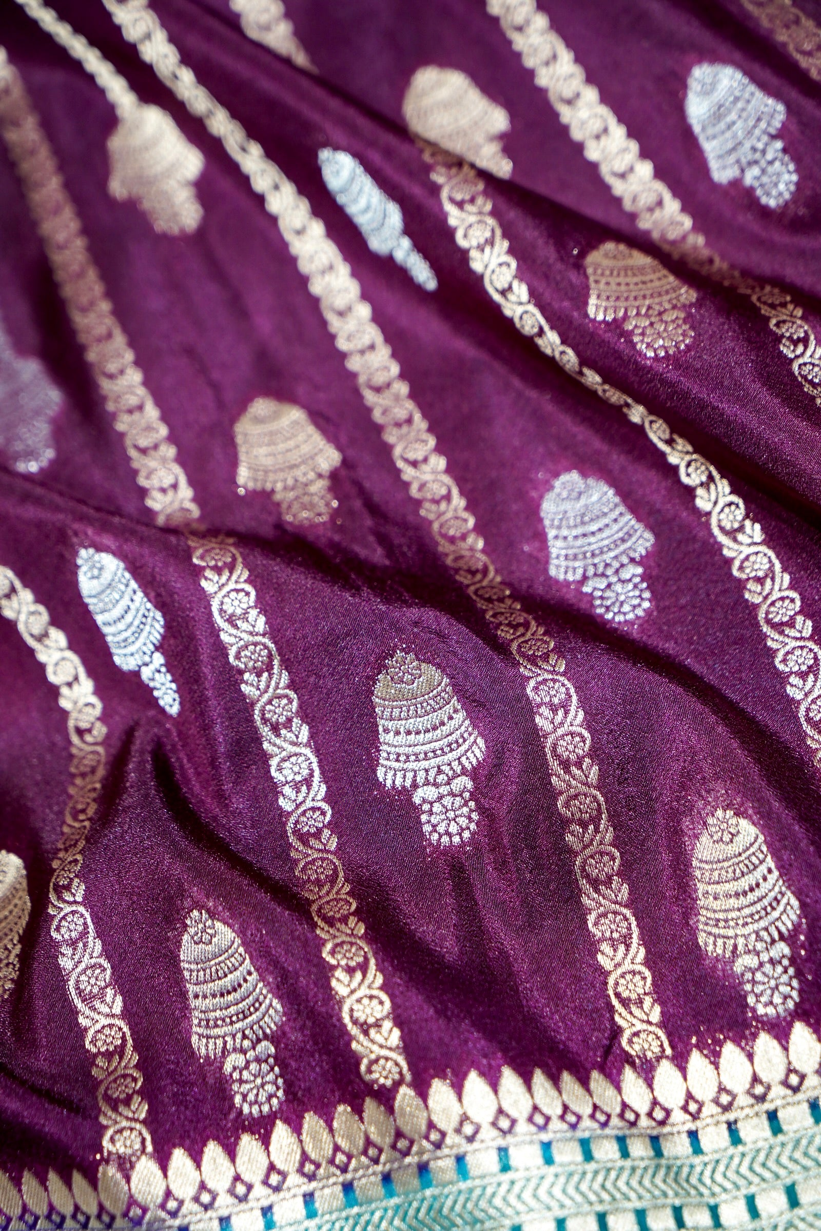 Wine Purple Bell Motifs Crepe Georgette Silk Saree with Teal Border