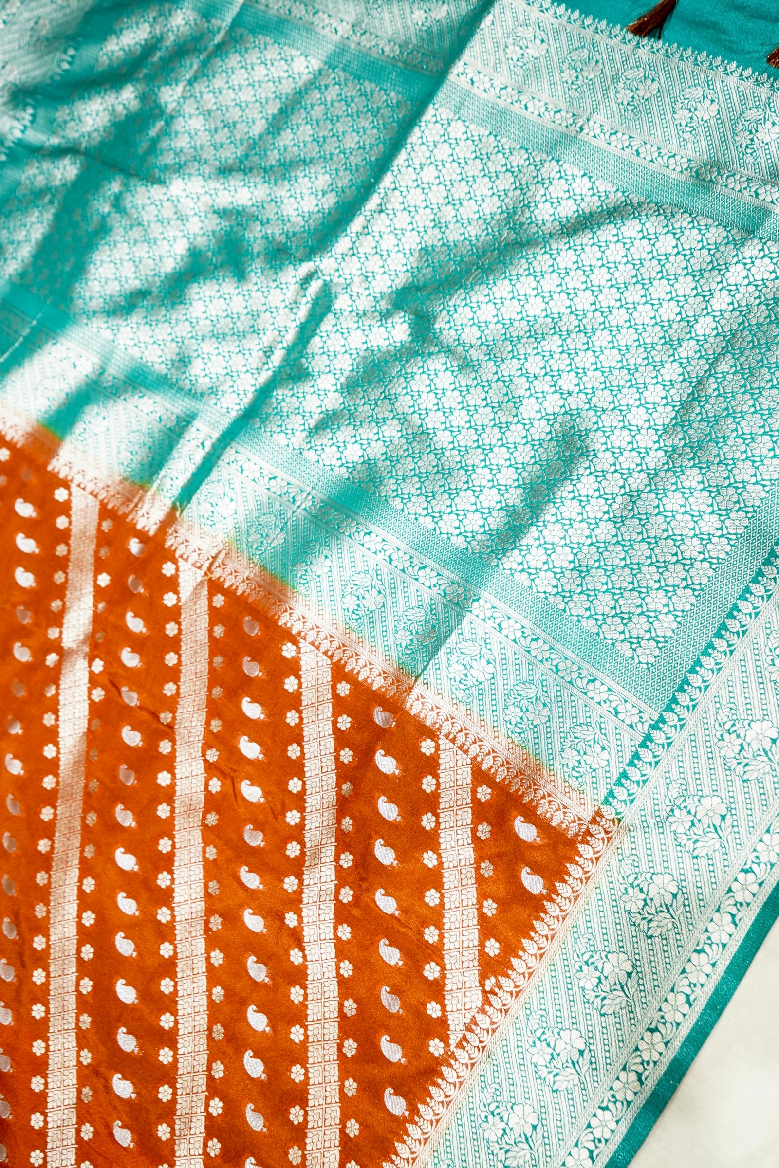 Rust Orange Paisley Crepe Georgette Silk Saree with Aqua Green Border