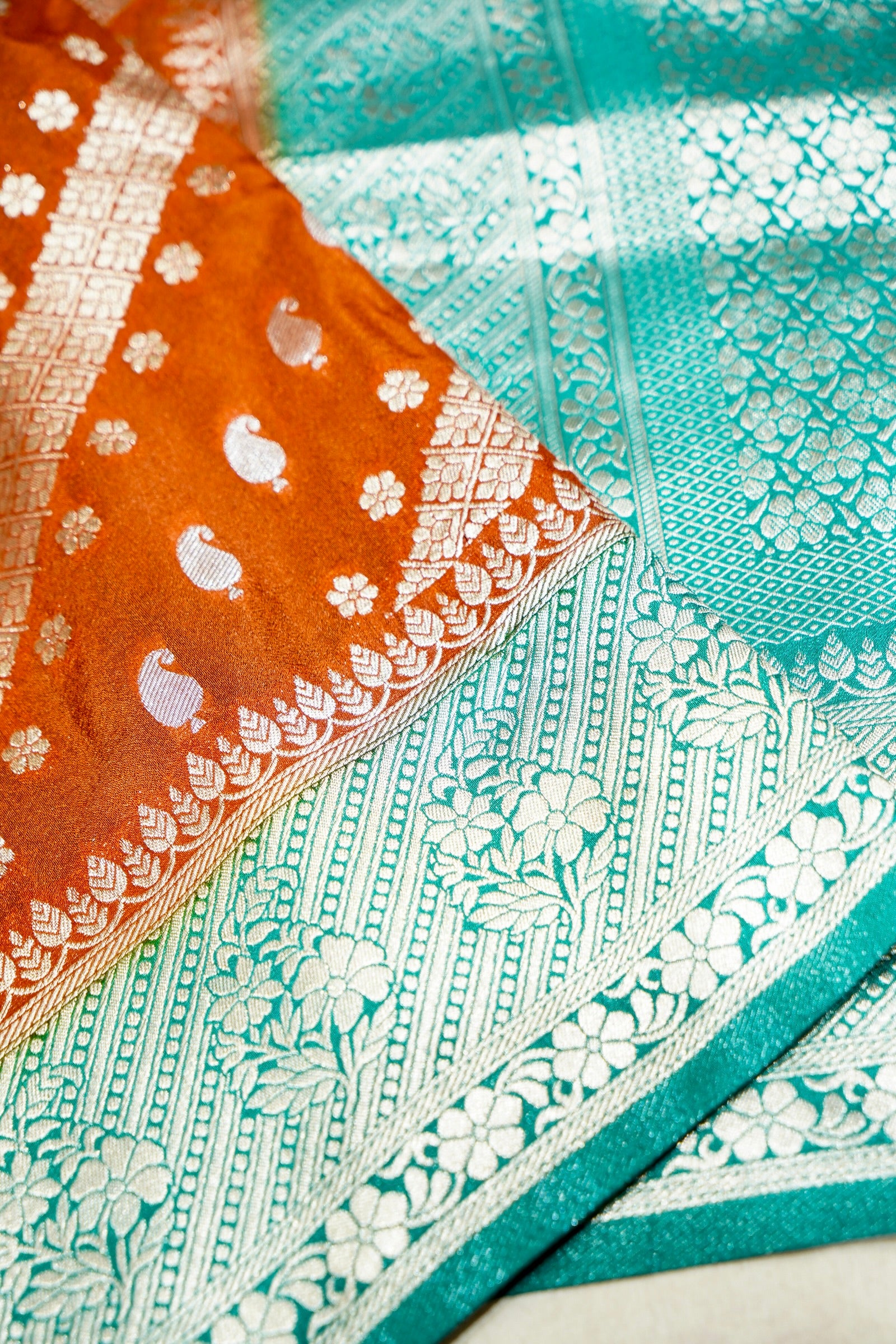 Rust Orange Paisley Crepe Georgette Silk Saree with Aqua Green Border