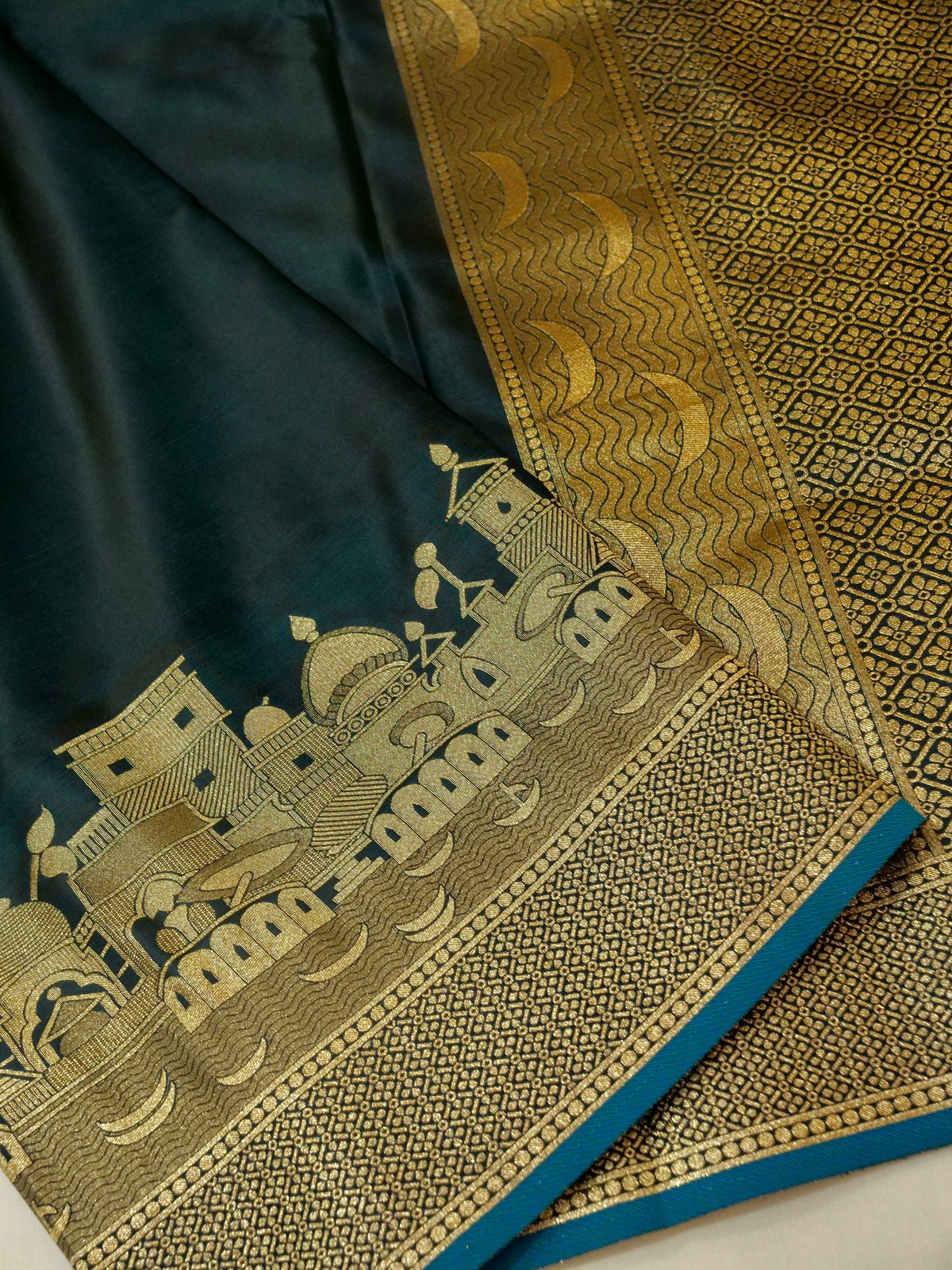 Nihar - Deep Teal Blue Ghat Border Banarasi Silk Saree with Stitched Blouse