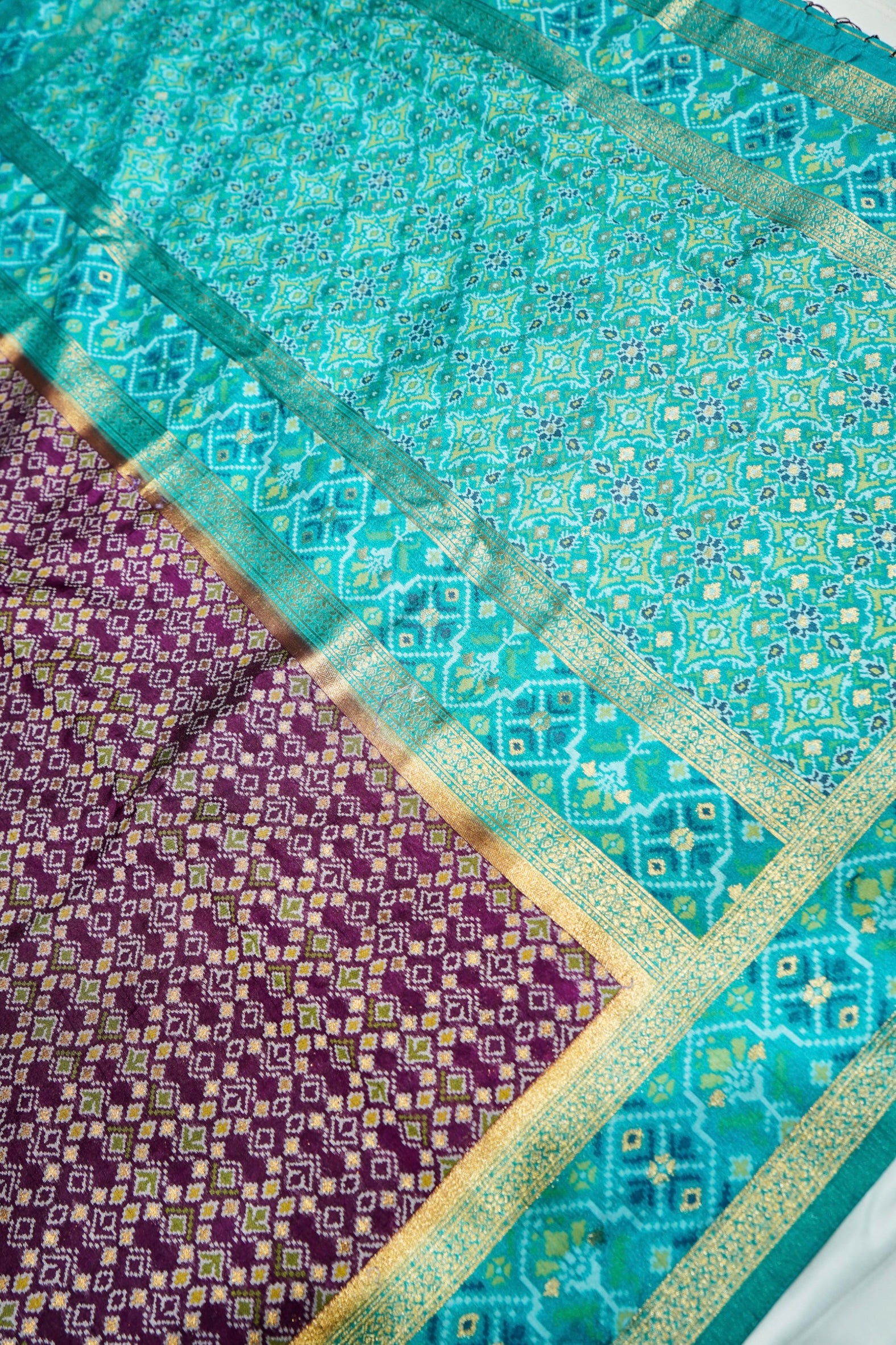 Wine Purple Ikkat Patola Silk Saree with Turquoise Blue Border