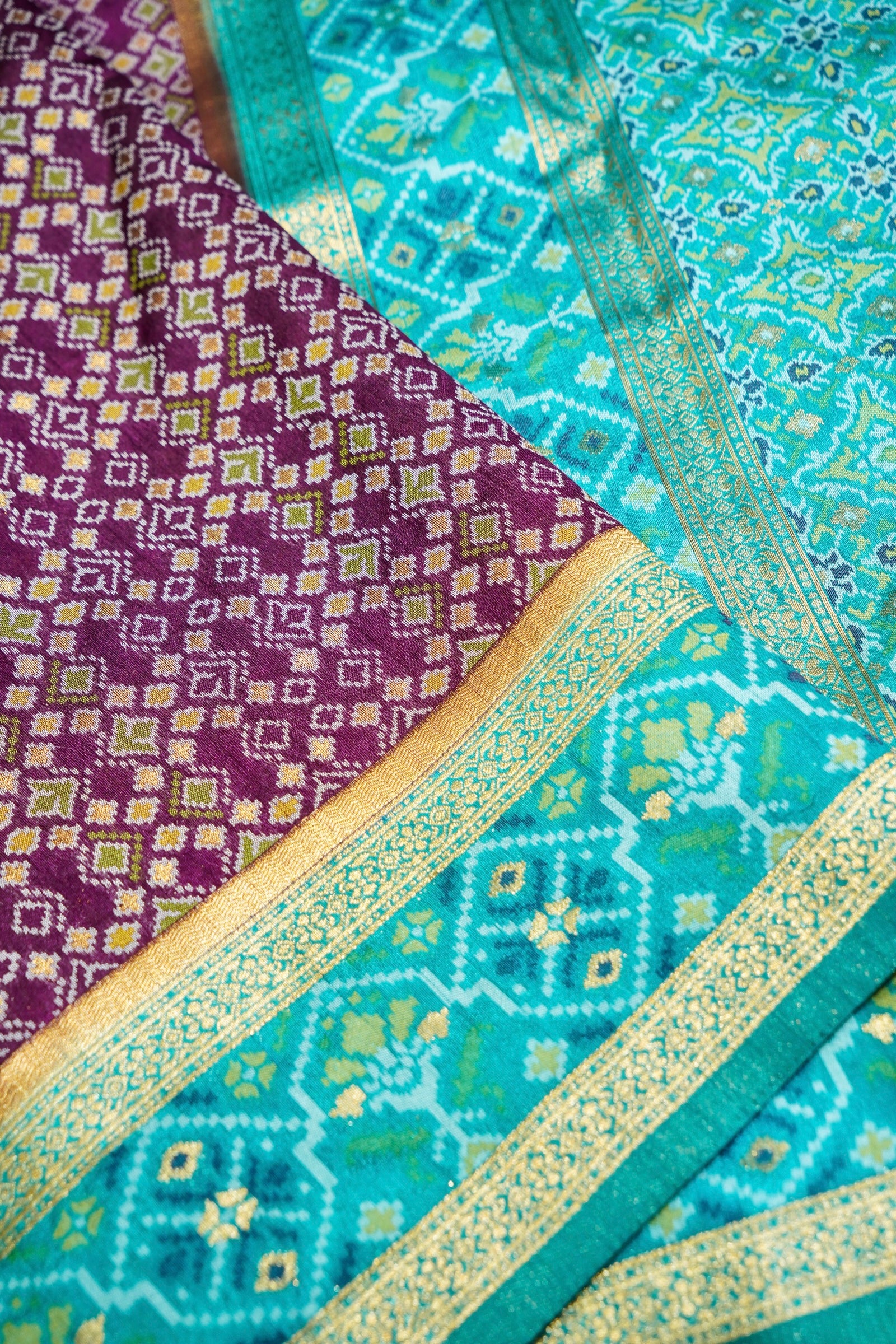 Wine Purple Ikkat Patola Silk Saree with Turquoise Blue Border