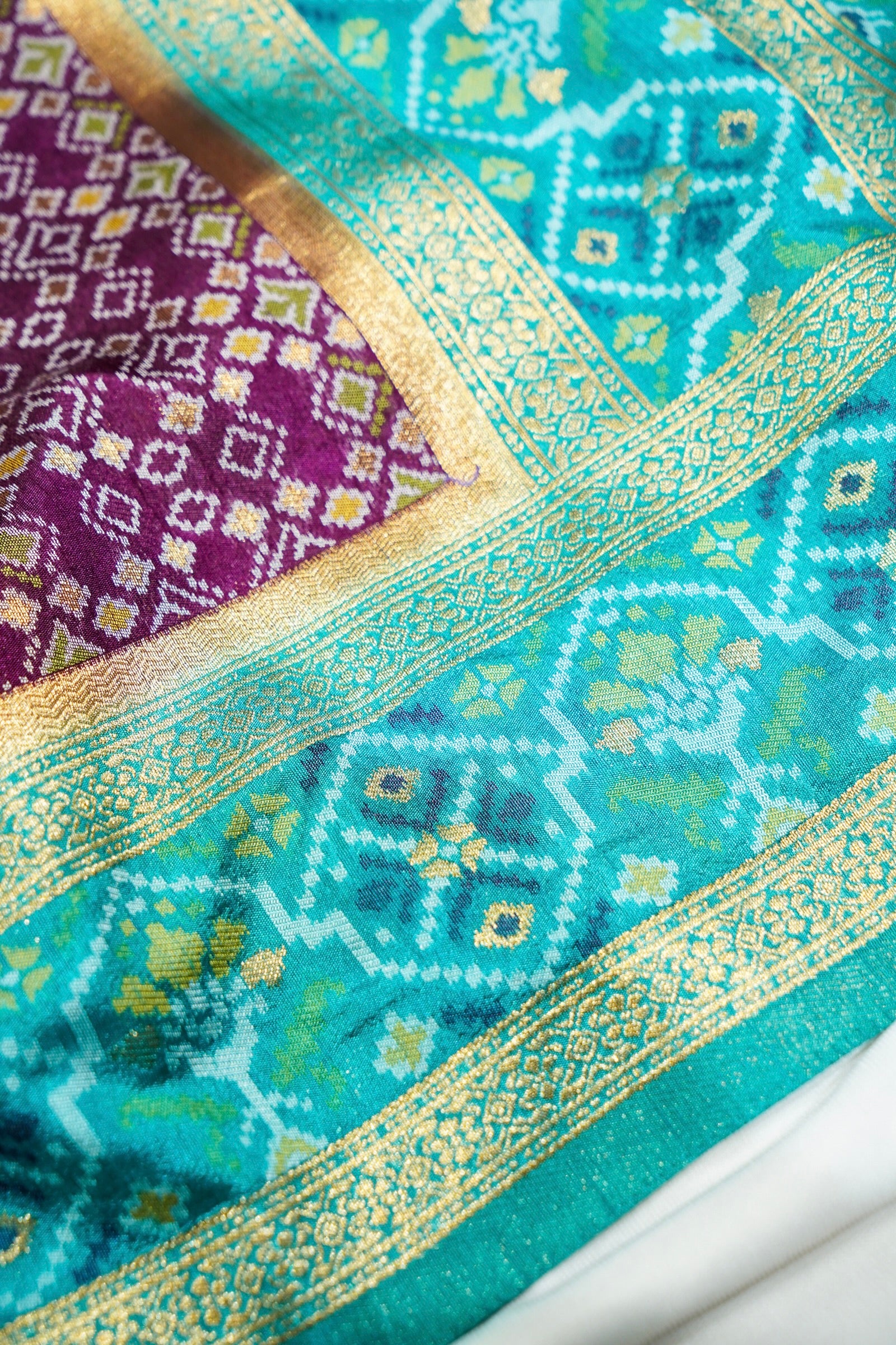 Wine Purple Ikkat Patola Silk Saree with Turquoise Blue Border