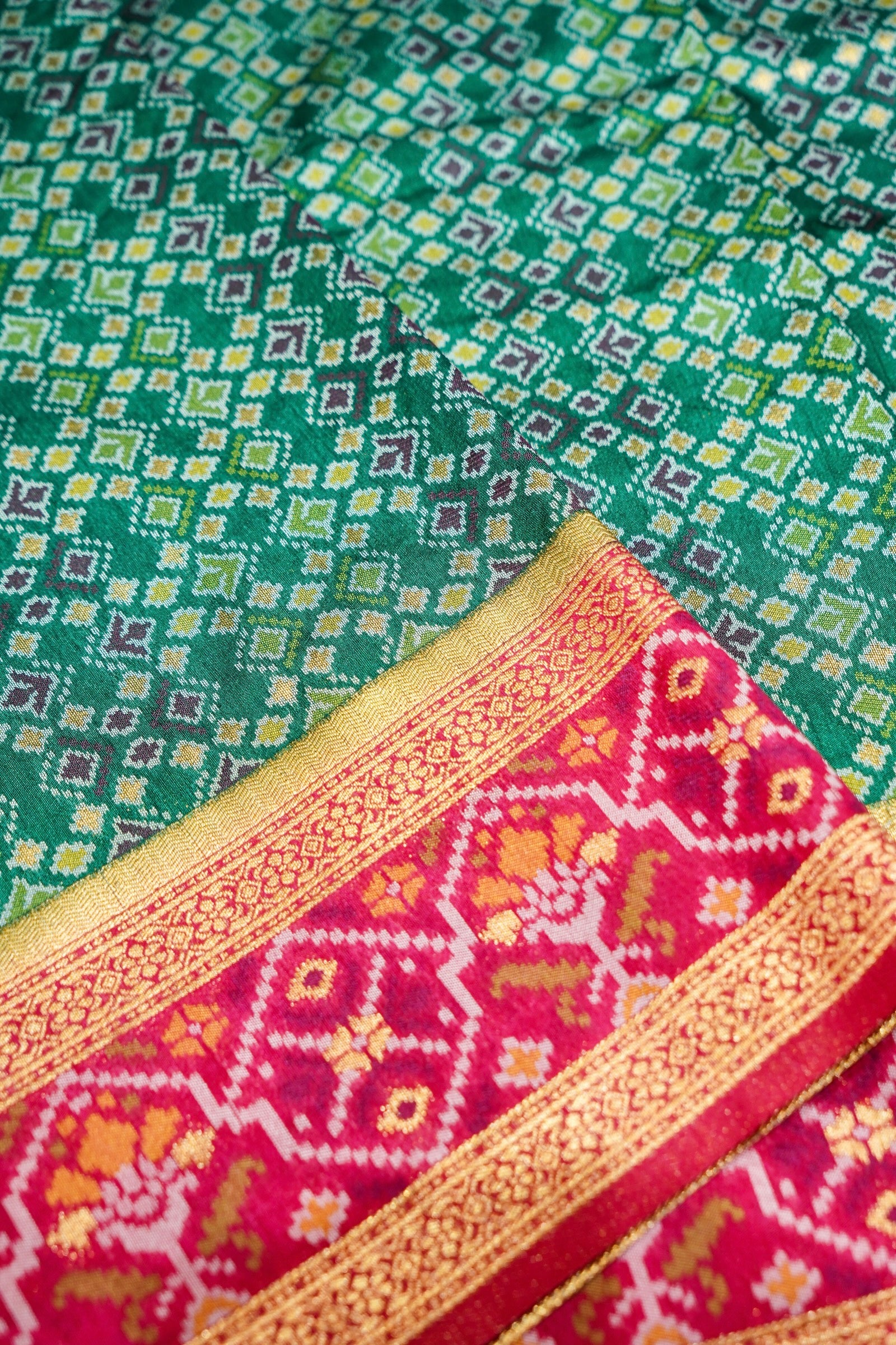 Emerald Green Ikkat Patola Silk Saree with Rani Pink Border