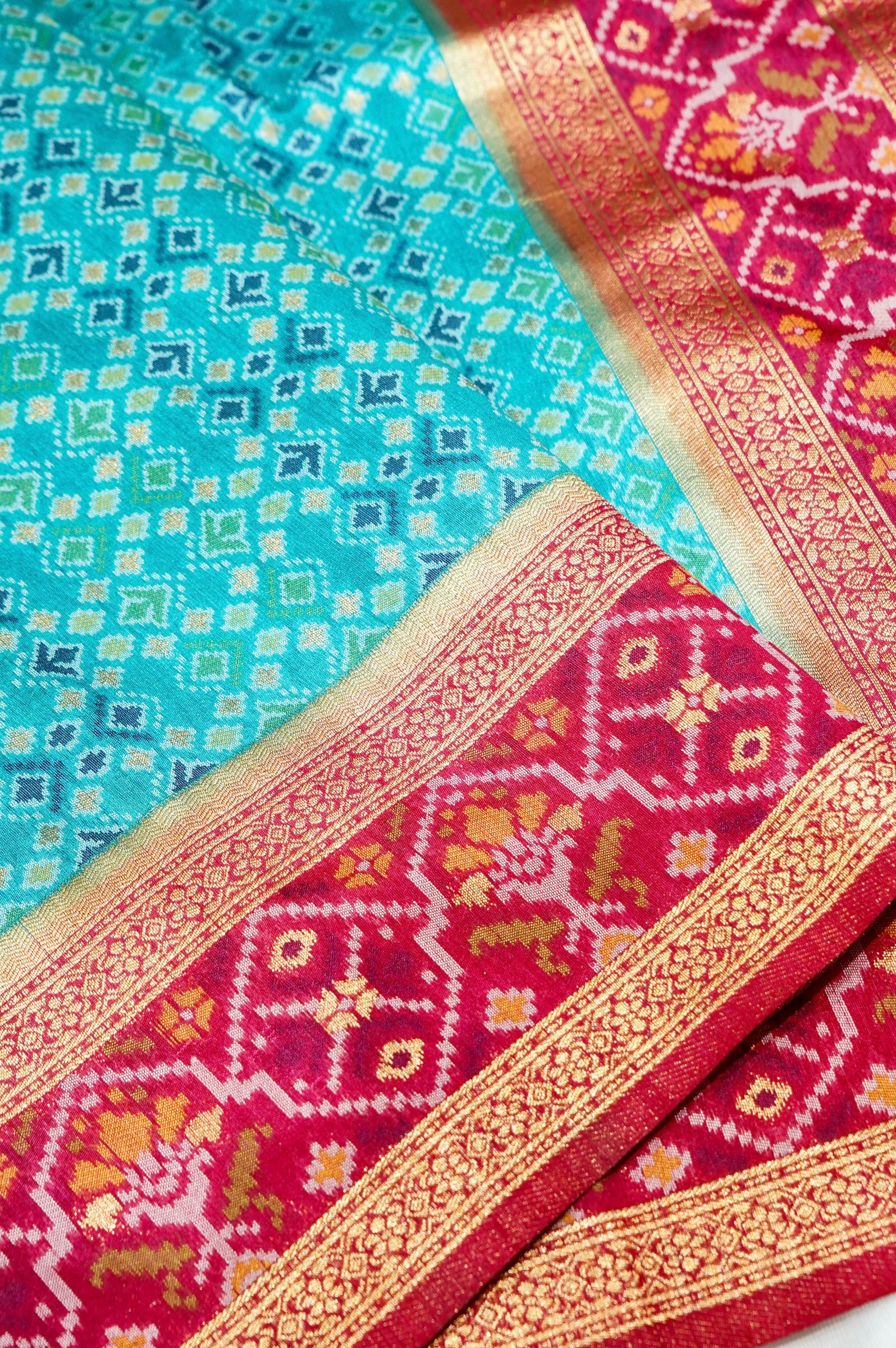 Aqua Blue Ikkat Patola Silk Saree with Rani Pink Border