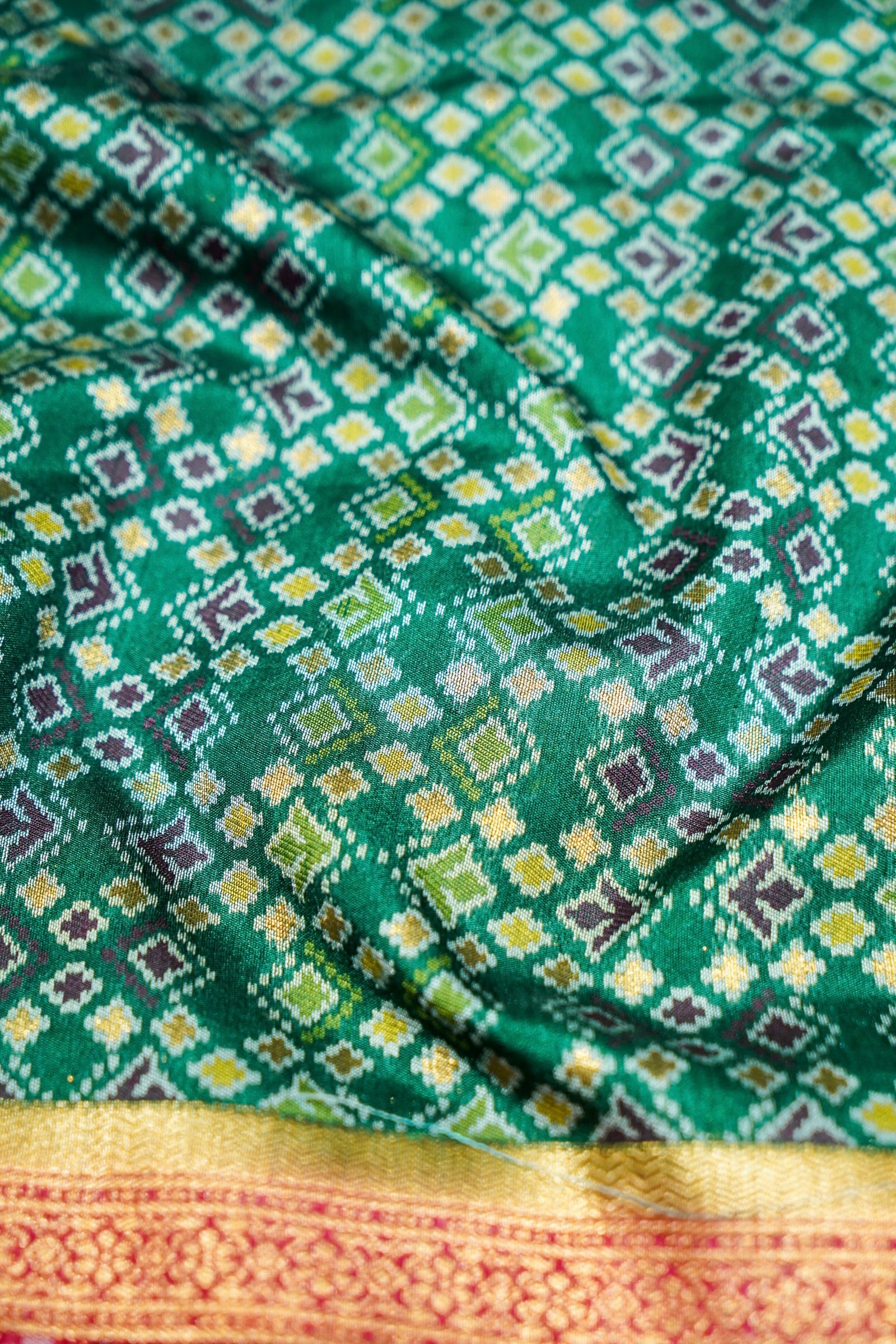 Emerald Green Ikkat Patola Silk Saree with Rani Pink Border
