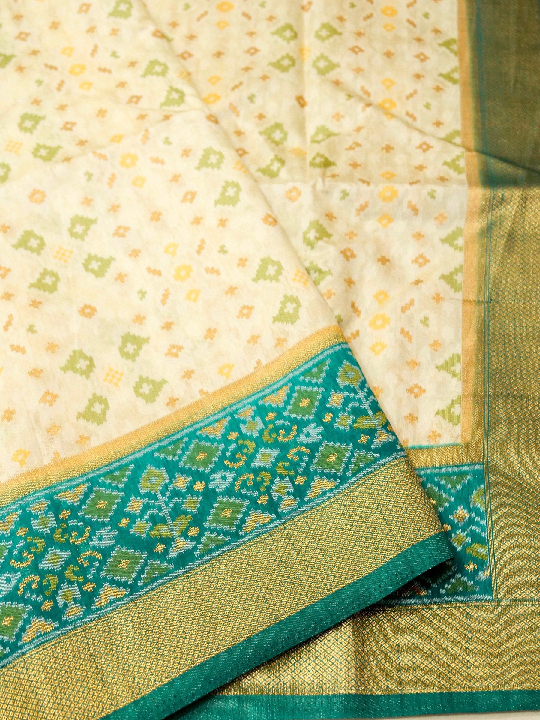 Soft Ivory Patola Silk Saree with Turquoise Green Border