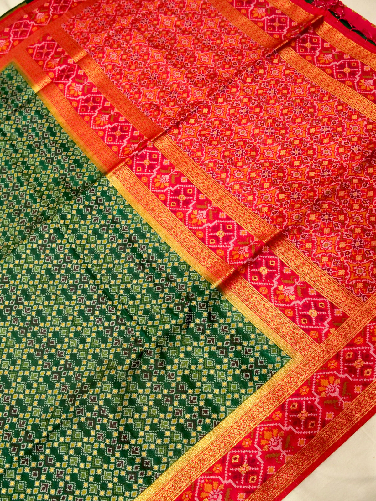 Emerald Green Patola Silk Saree with Contrast Rani Pink Border