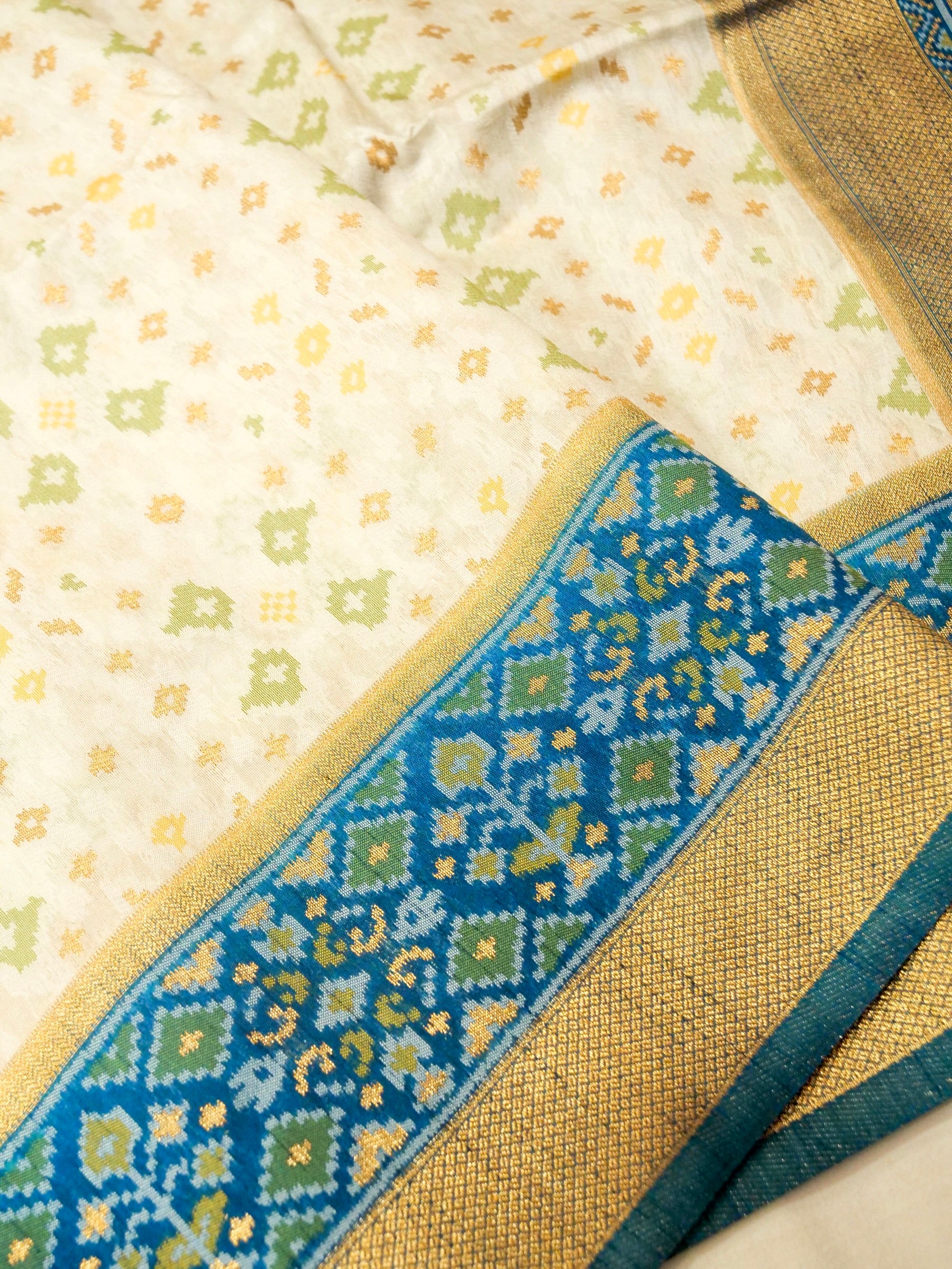 Soft Ivory Patola Silk Saree with Peacock Blue Border