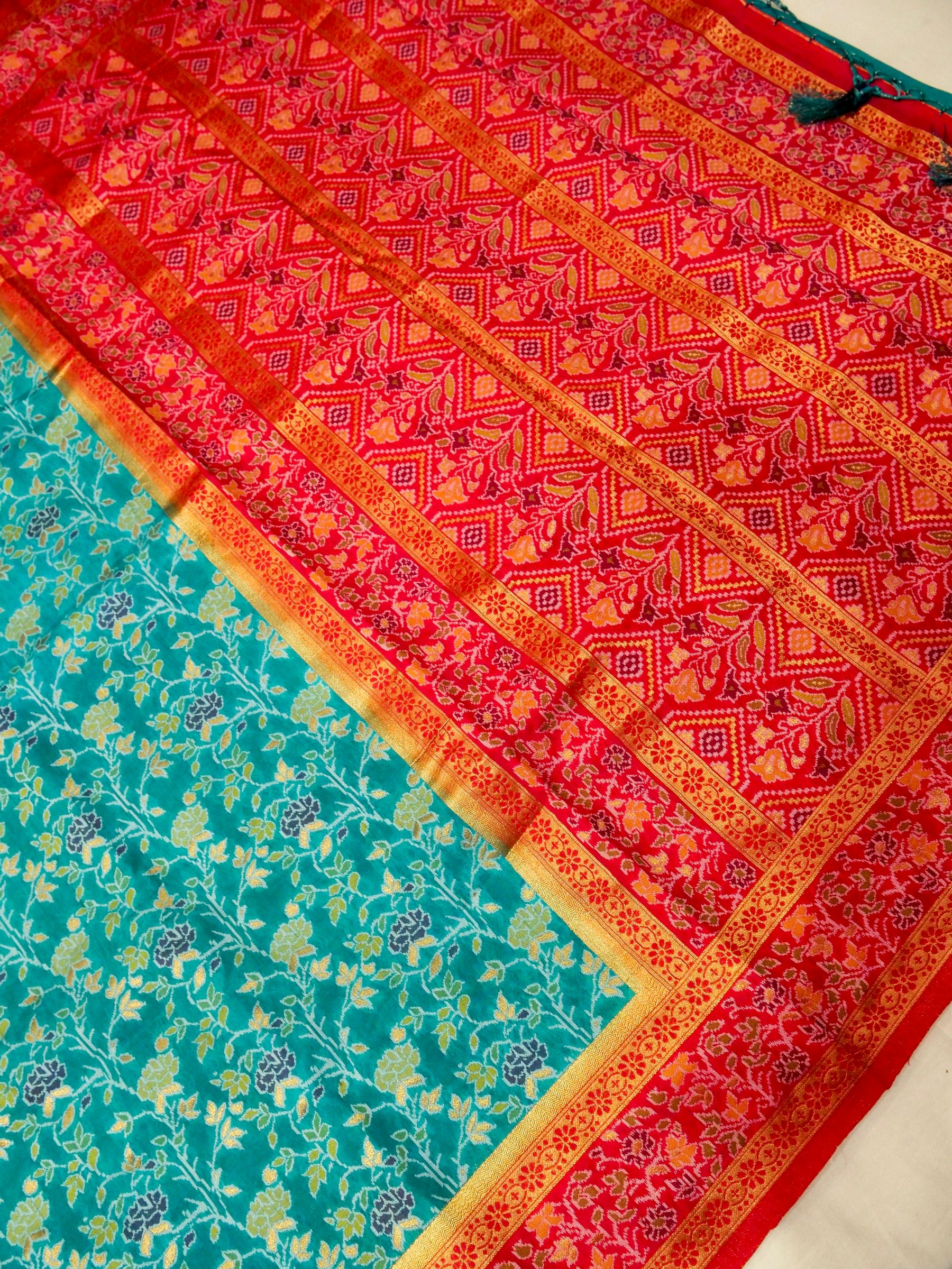 Sea Green Patola Silk Saree with Contrast Rani Pink Floral Zari Border