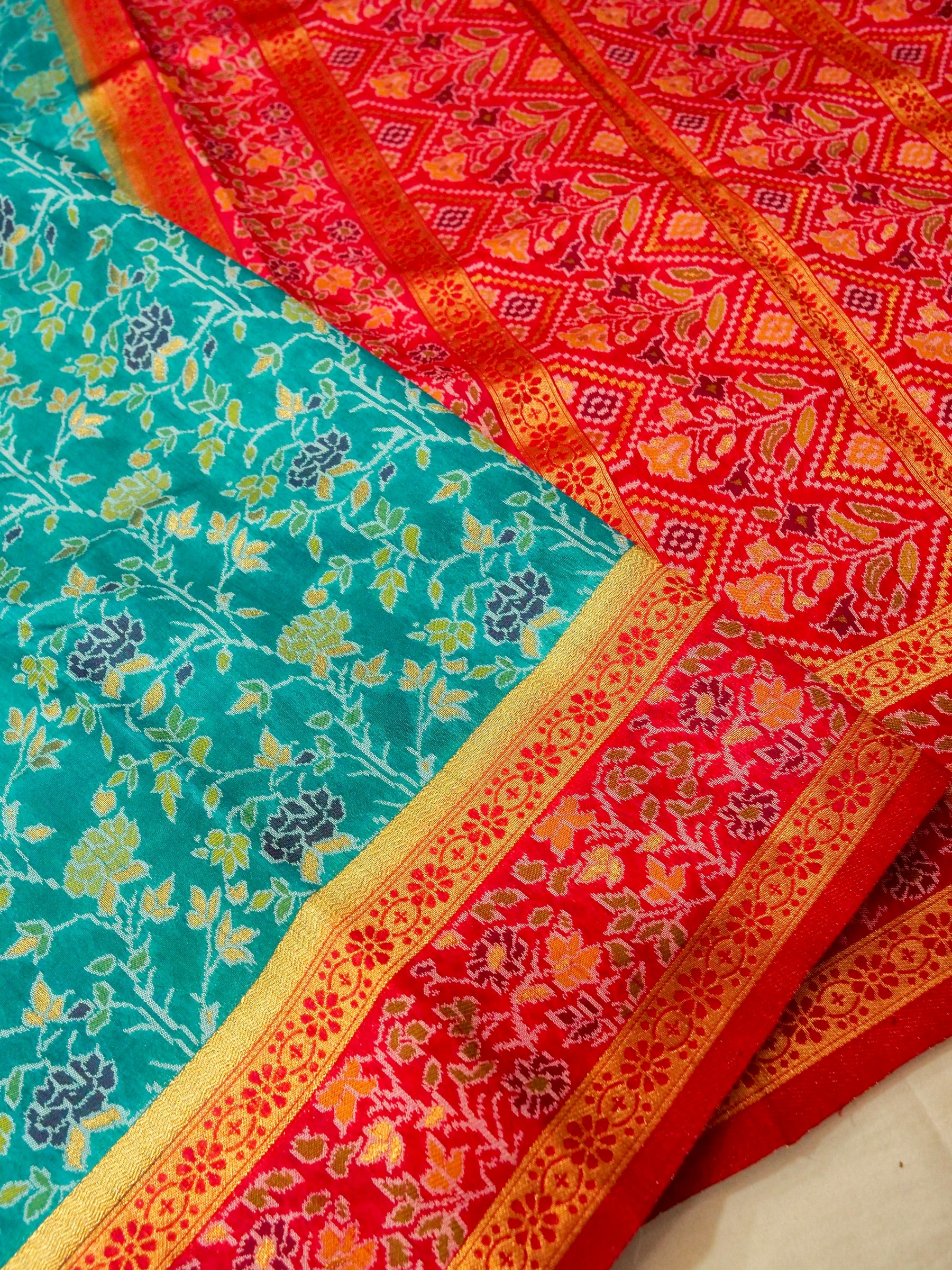 Sea Green Patola Silk Saree with Contrast Rani Pink Floral Zari Border