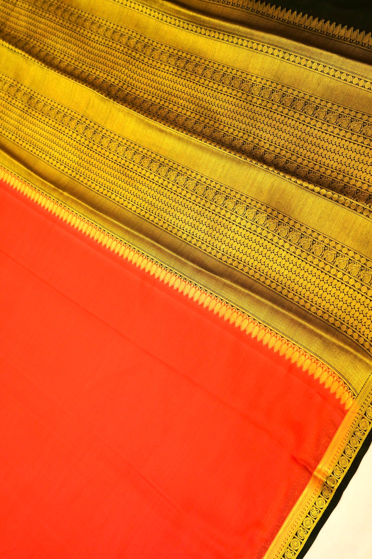 Maithili - Coral Red Mysore Crepe Silk Saree with Black Border