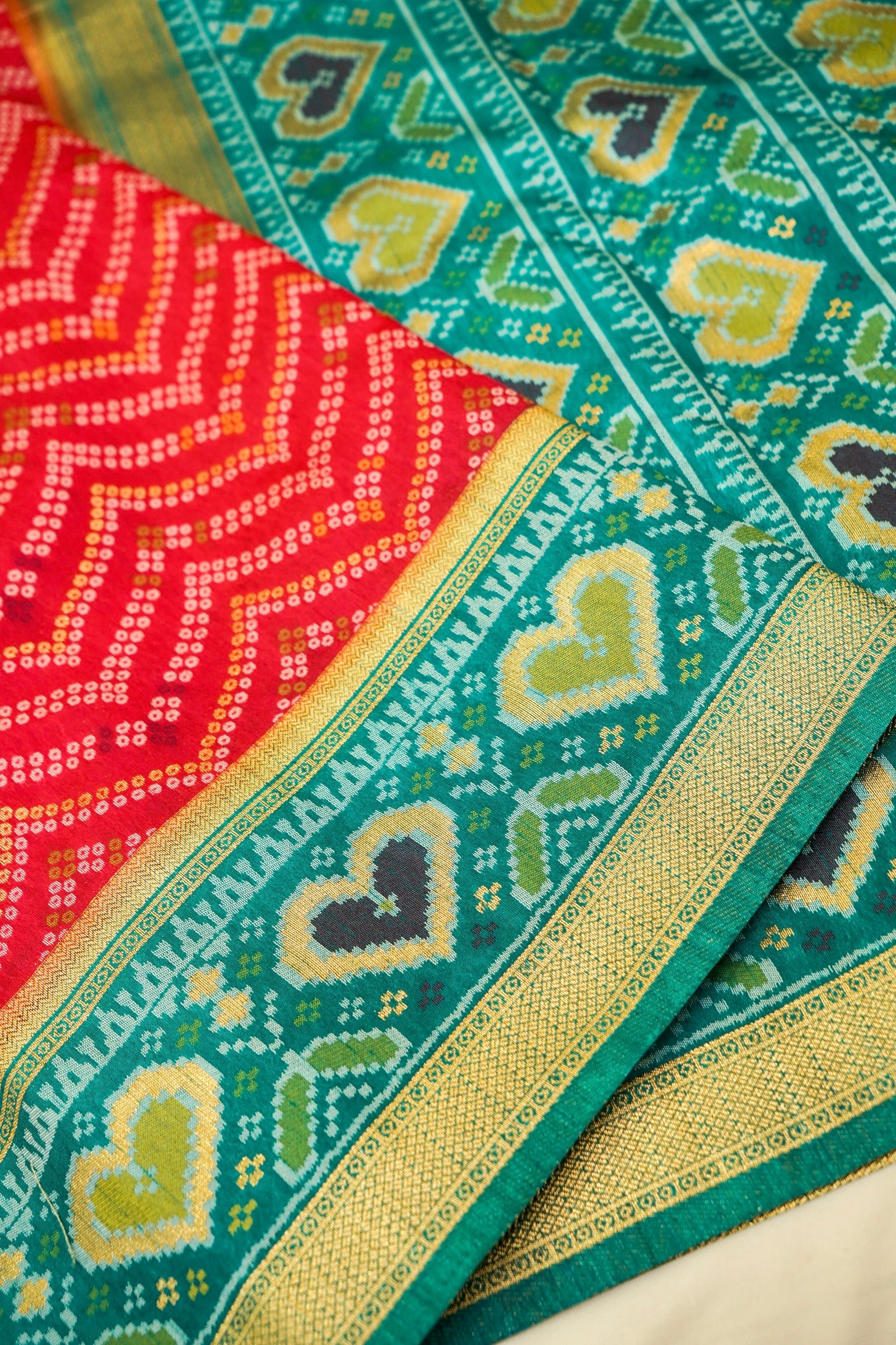 Bright Red Ikkat Patola Silk Saree with Teal Border and Stitched Blouse