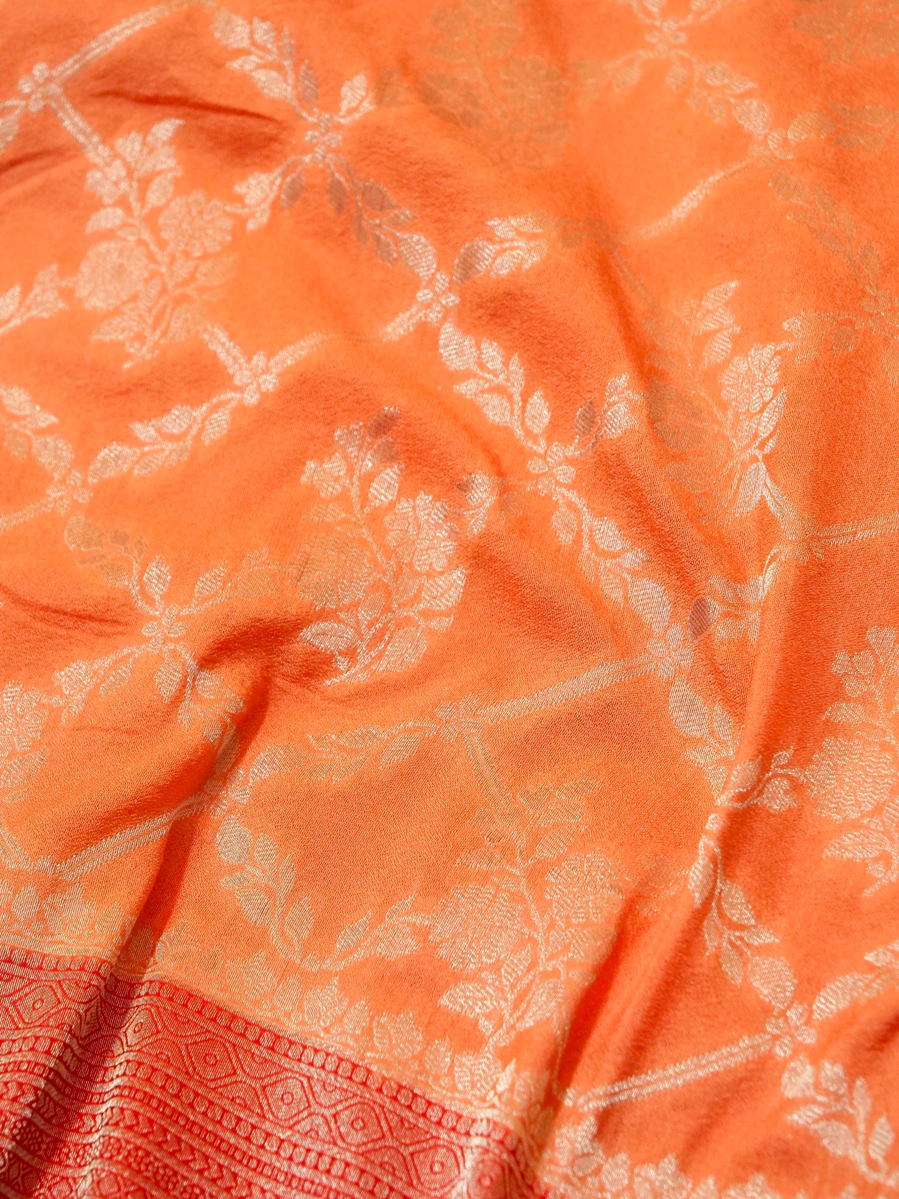 Pastel Orange Crepe Georgette Silk Saree with Red Border
