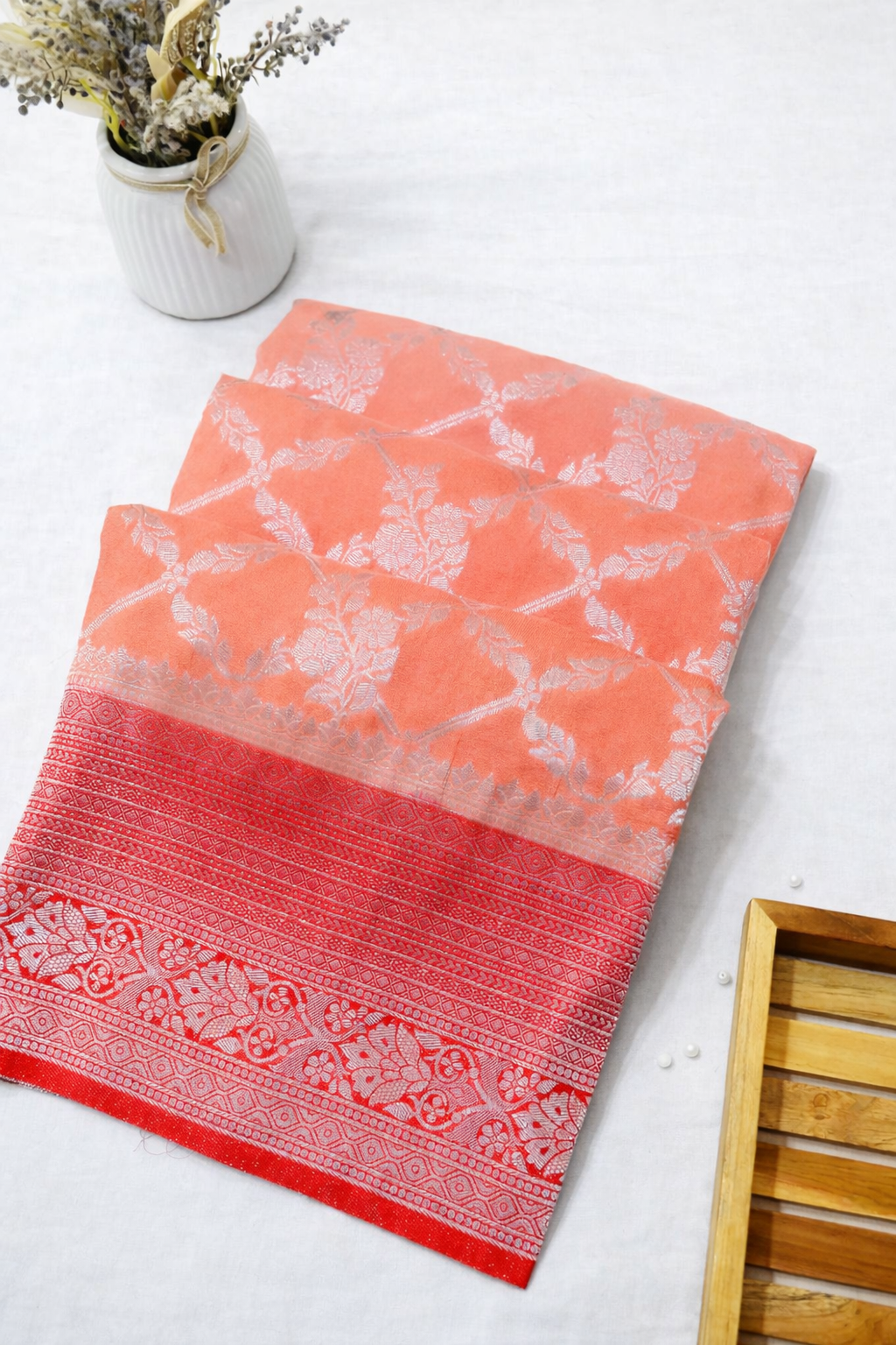 Pastel Orange Crepe Georgette Silk Saree with Red Border