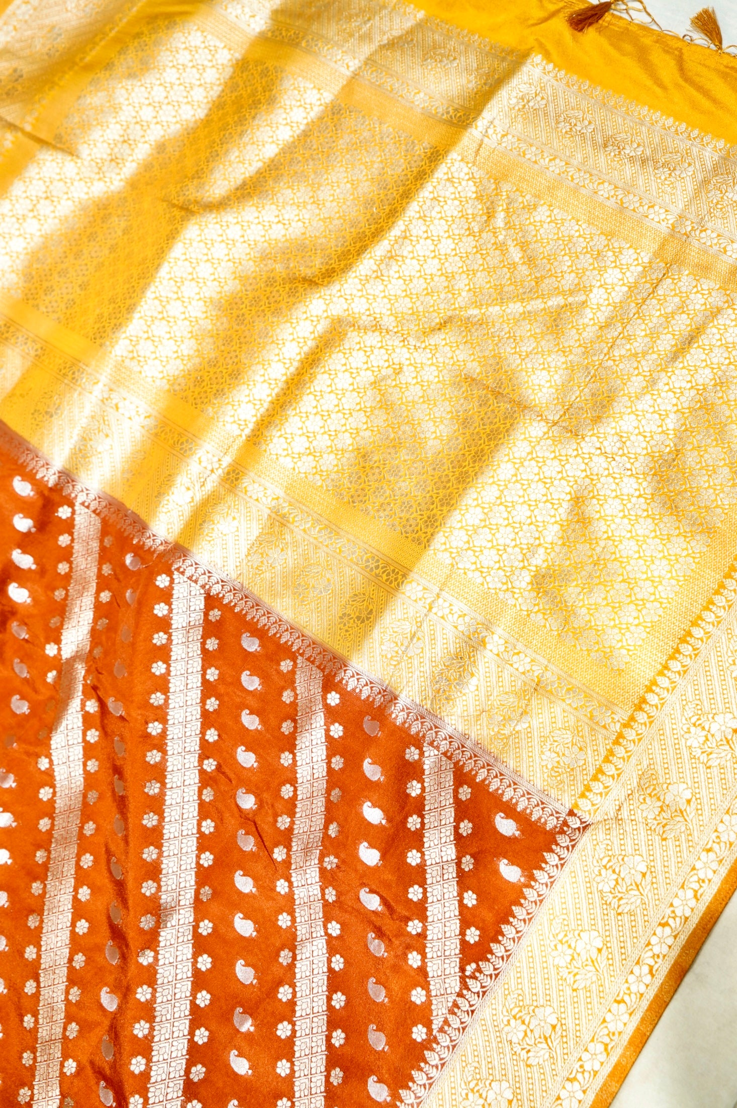 Rust Orange Paisley Crepe Georgette Silk Saree with Golden Yellow Border