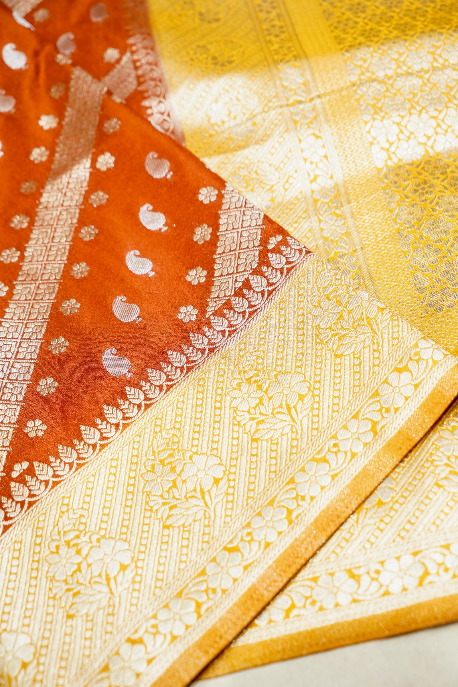 Rust Orange Paisley Crepe Georgette Silk Saree with Golden Yellow Border