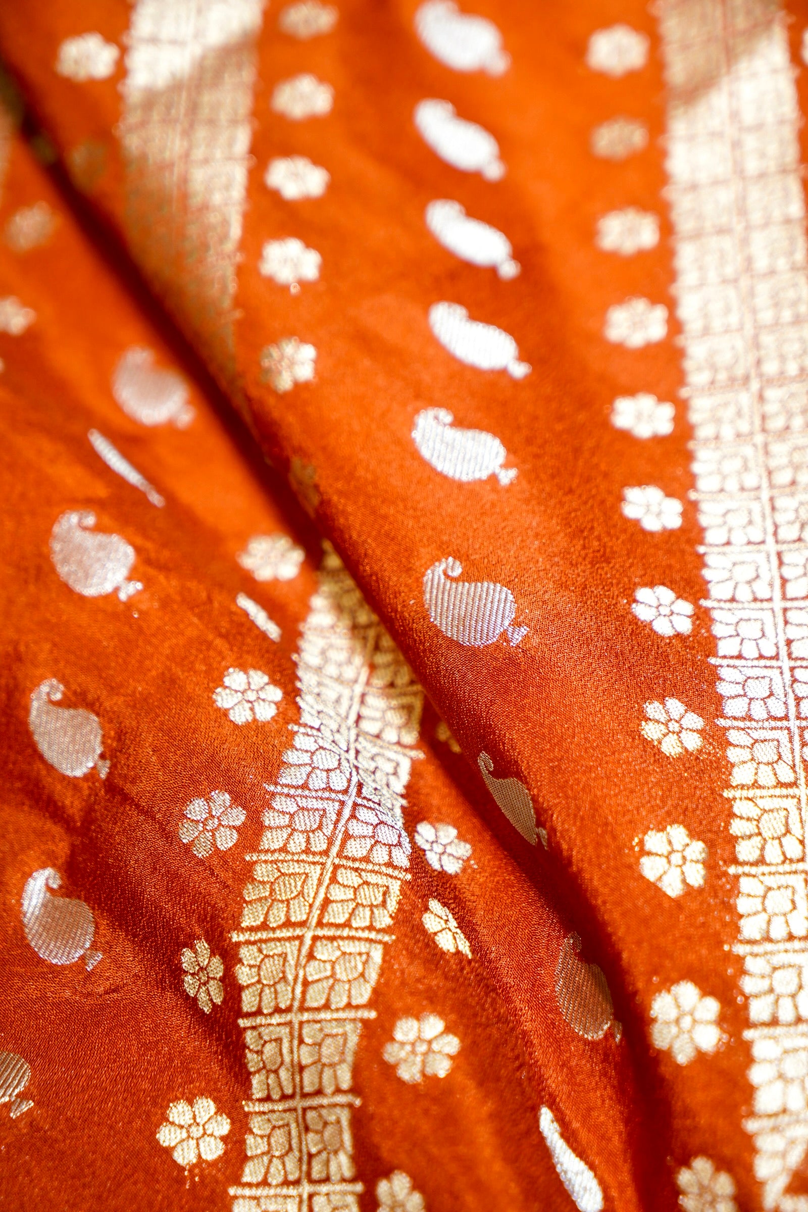 Rust Orange Paisley Crepe Georgette Silk Saree with Golden Yellow Border