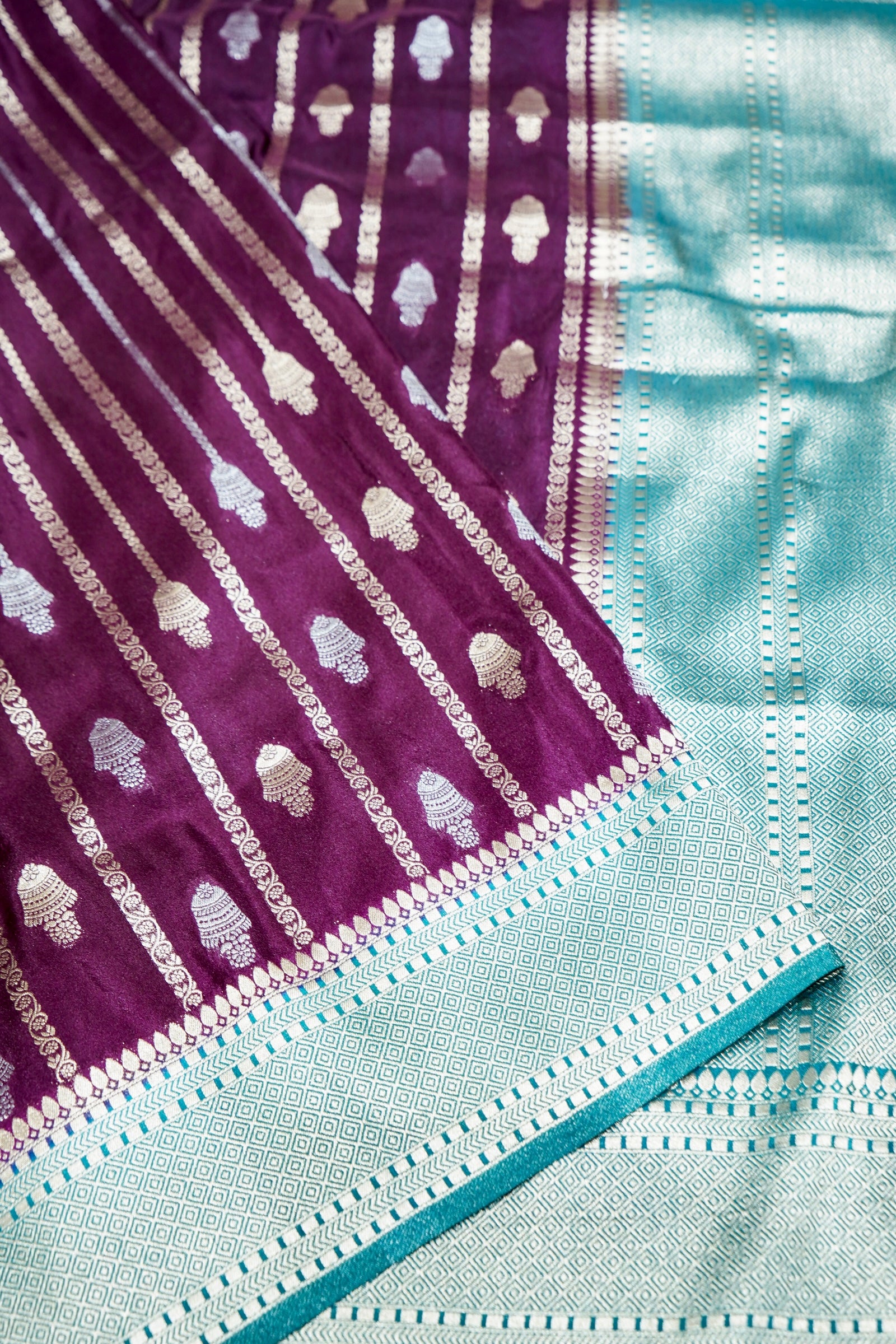 Wine Purple Bell Motifs Crepe Georgette Silk Saree with Teal Border