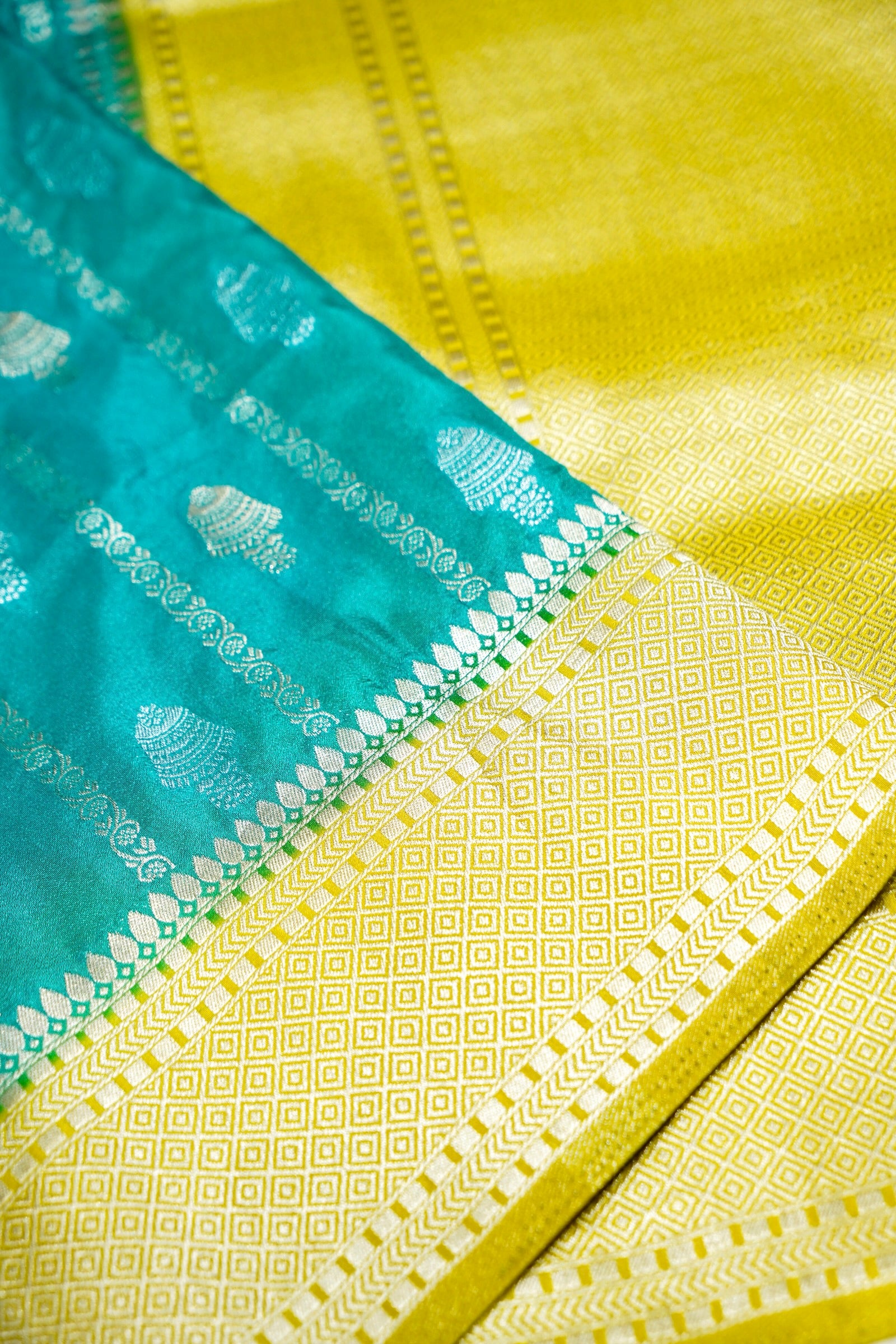 Turquoise Blue Bell Motifs Crepe Georgette Silk Saree with line green Border