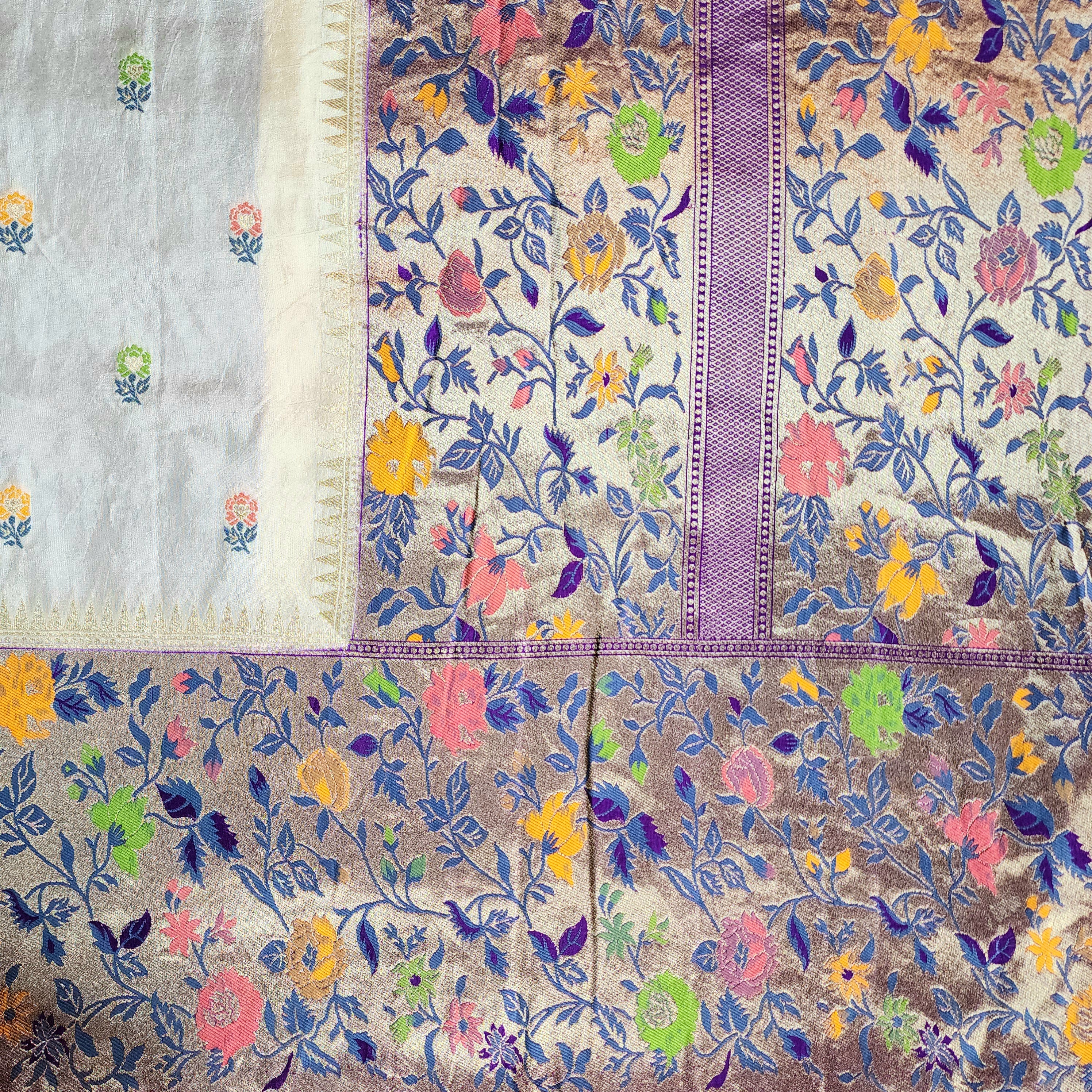 Soft Ivory Raw Silk Saree With Pastel Floral Weaving and Lilac Purple Border