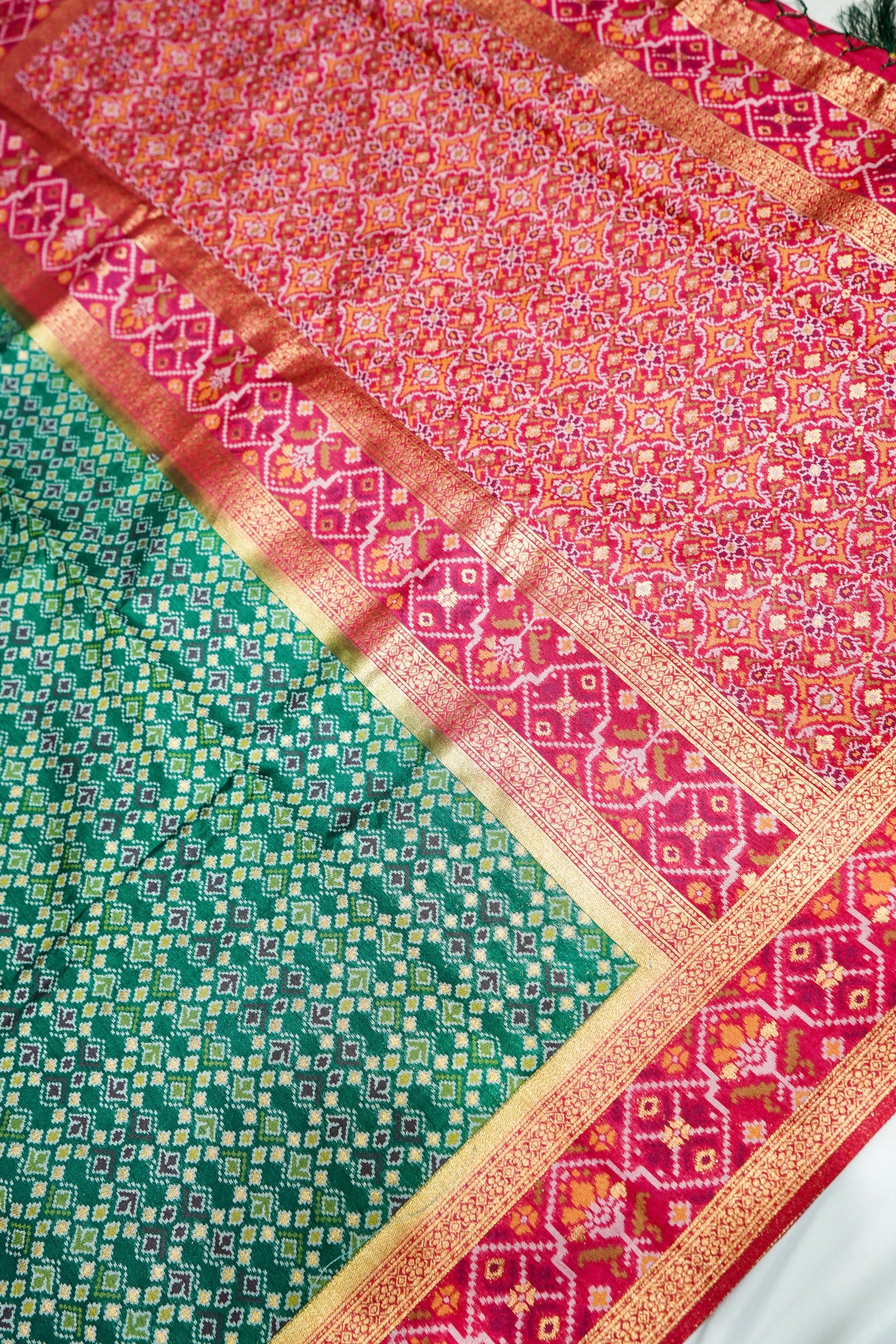 Emerald Green Ikkat Patola Silk Saree with Rani Pink Border