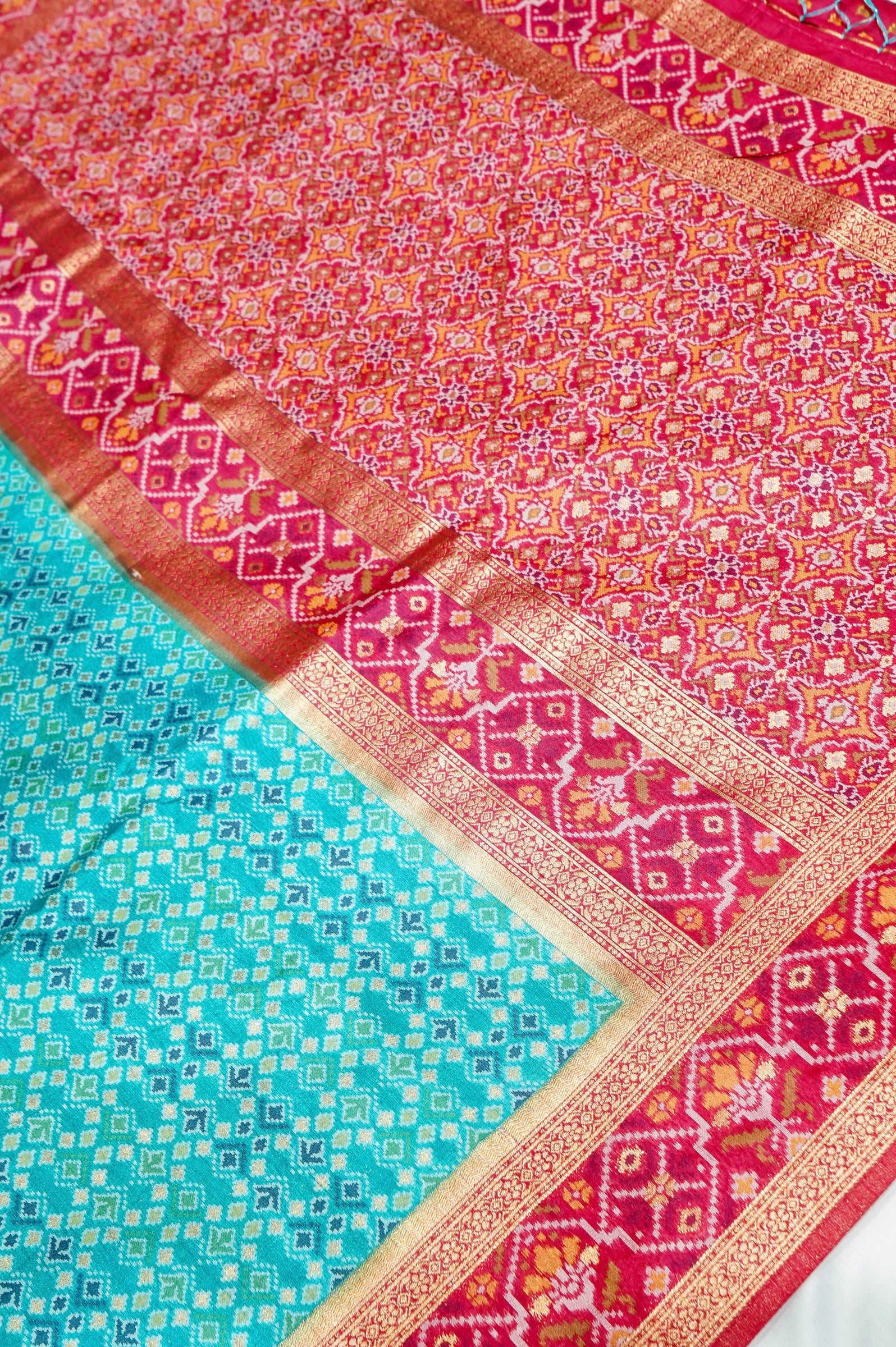 Aqua Blue Ikkat Patola Silk Saree with Rani Pink Border