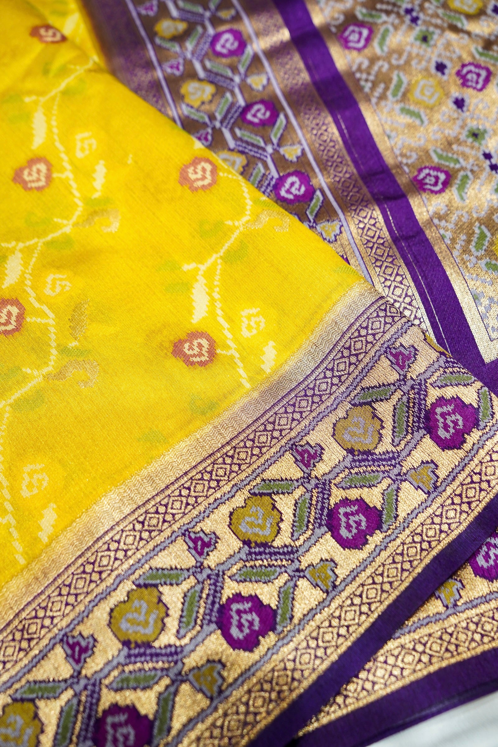 Sunshine Yellow Ikkat Patola Silk Saree with Violet Border