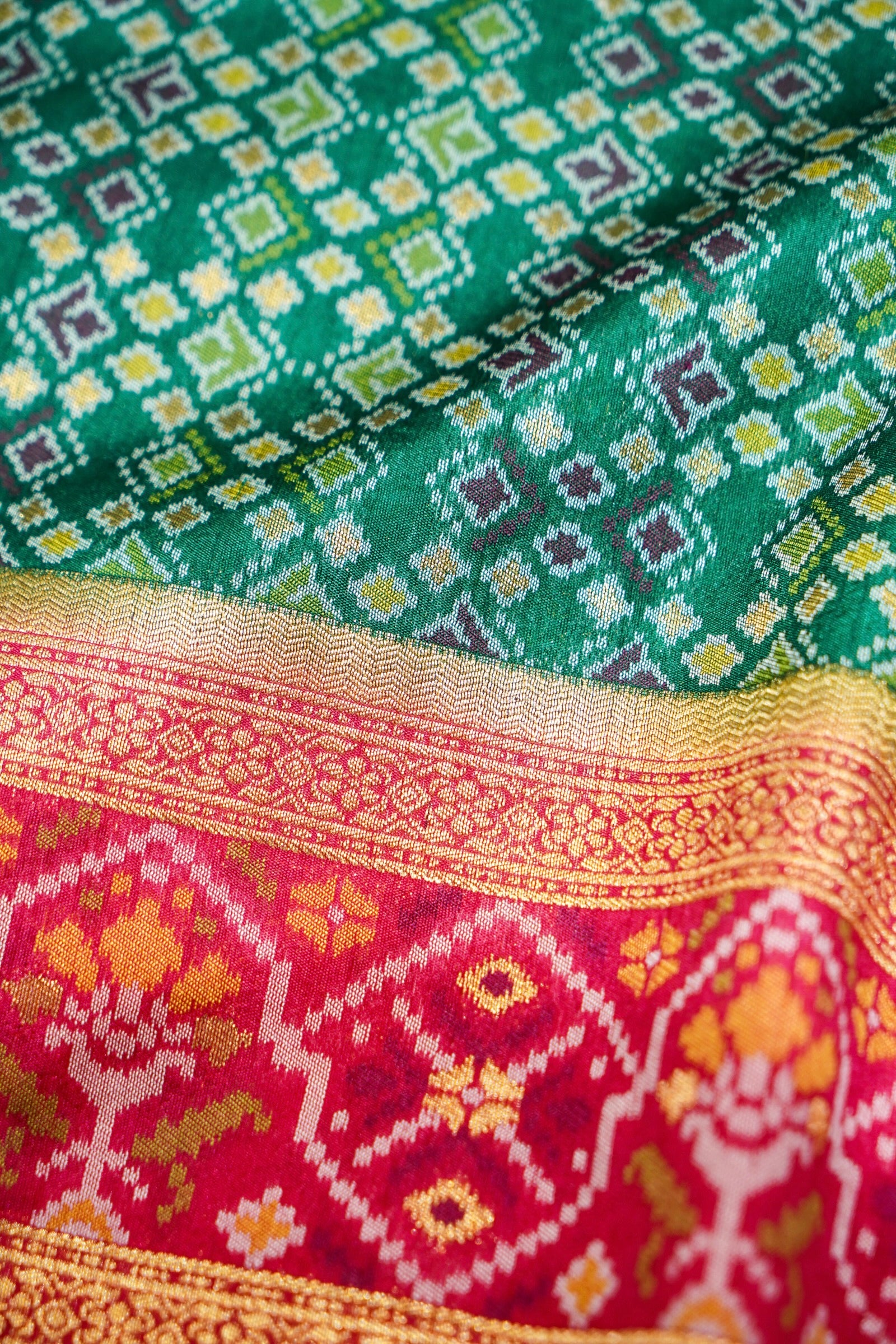 Emerald Green Ikkat Patola Silk Saree with Rani Pink Border