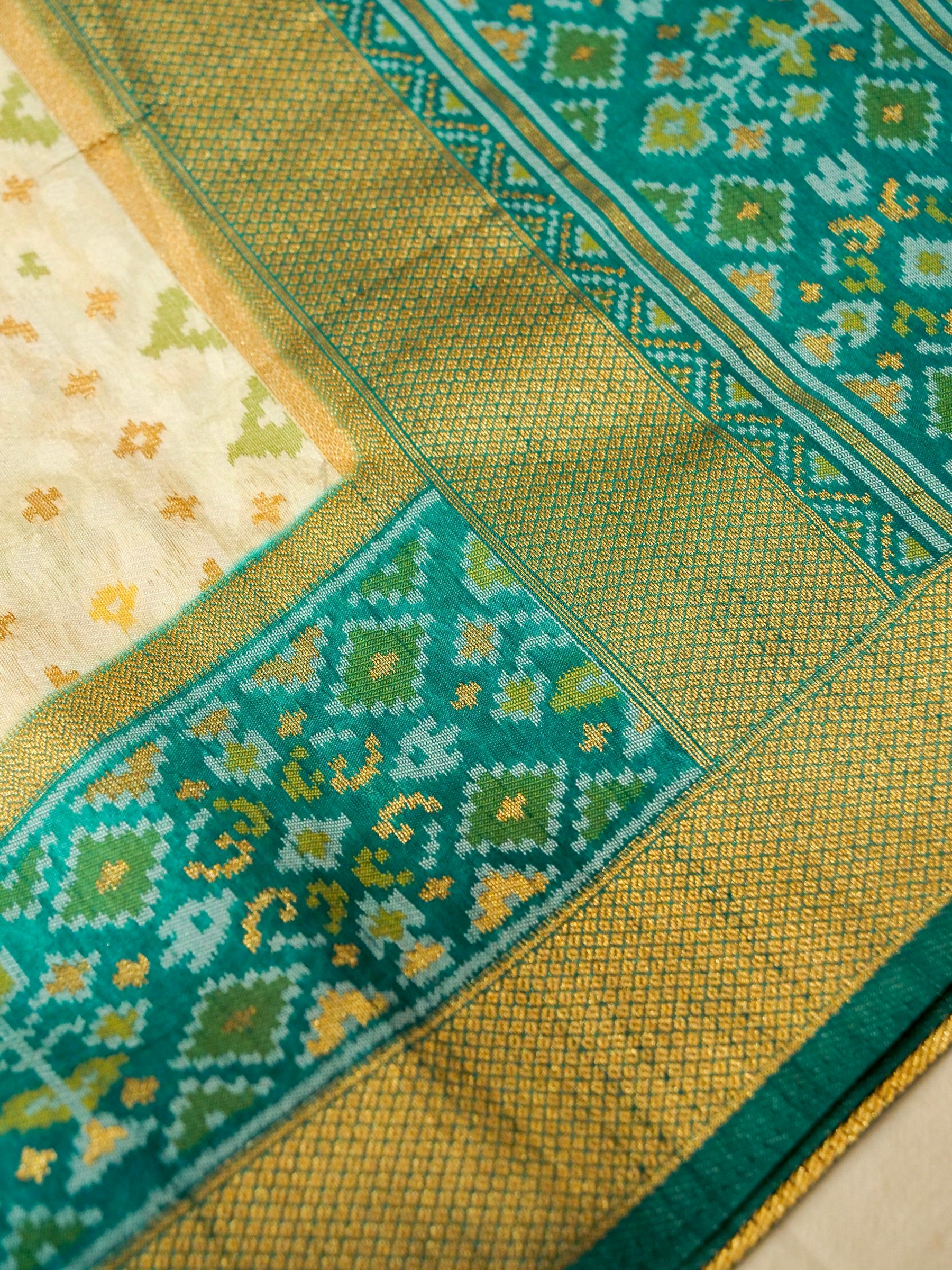 Soft Ivory Patola Silk Saree with Turquoise Green Border