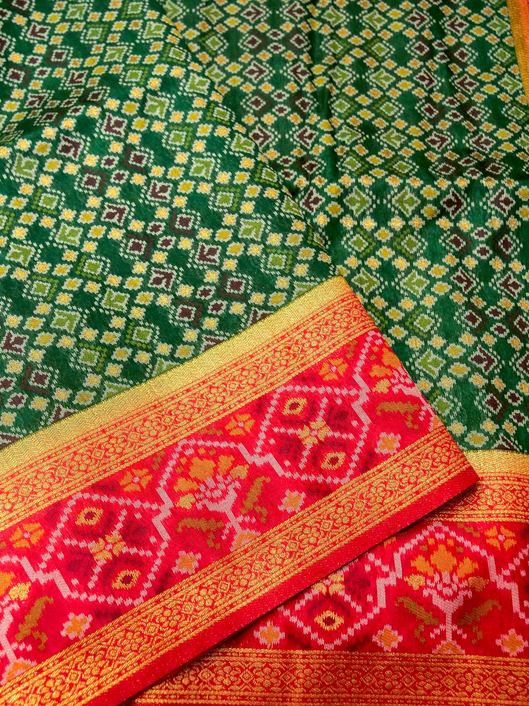 Emerald Green Patola Silk Saree with Contrast Rani Pink Border