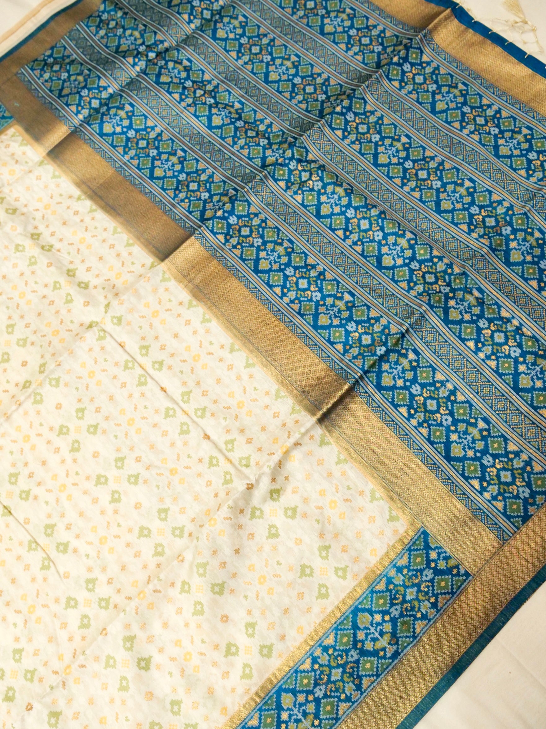 Soft Ivory Patola Silk Saree with Peacock Blue Border