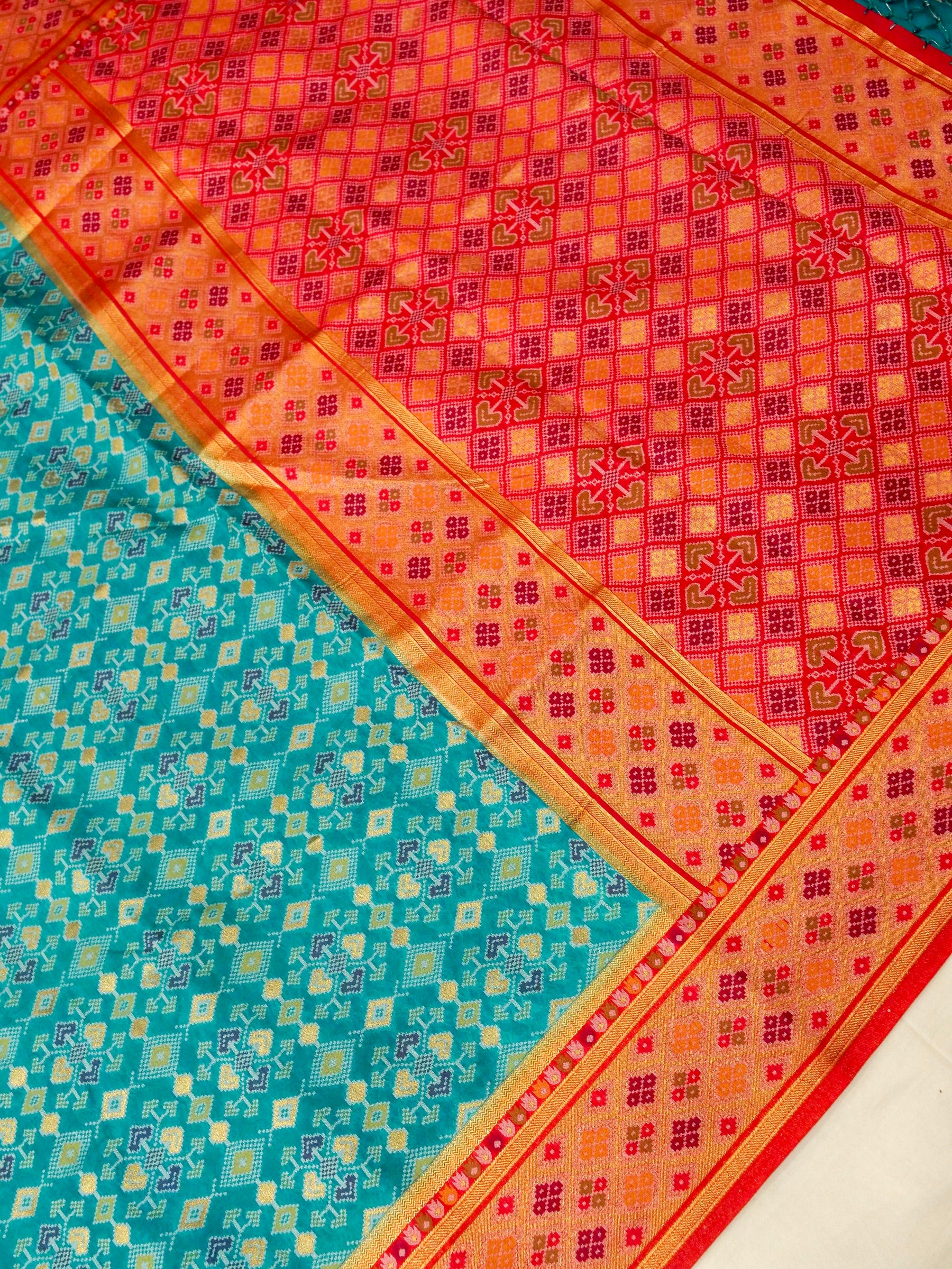 Turquoise Patola Silk Saree with Contrast Peach Pink Border