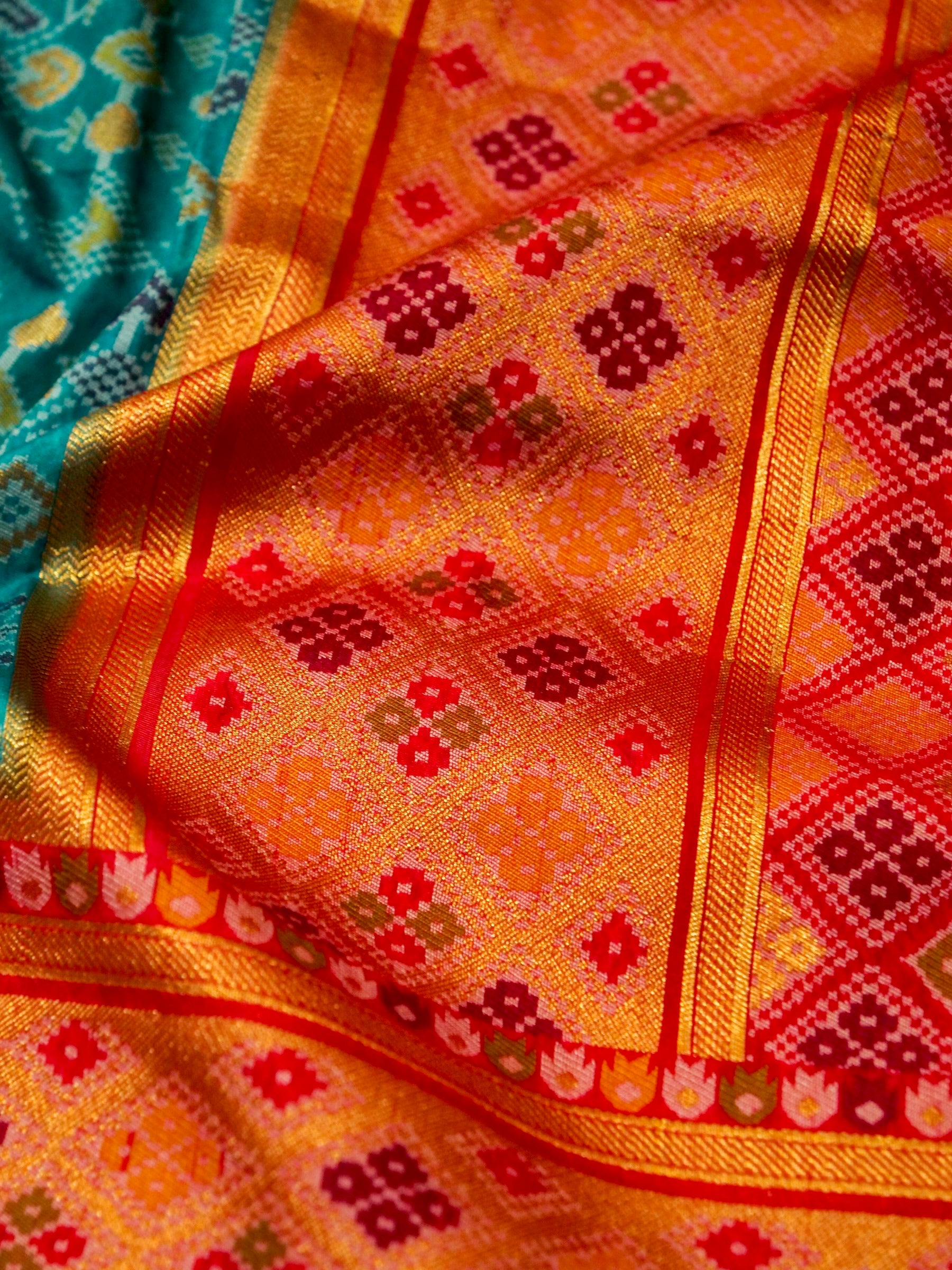 Turquoise Patola Silk Saree with Contrast Peach Pink Border