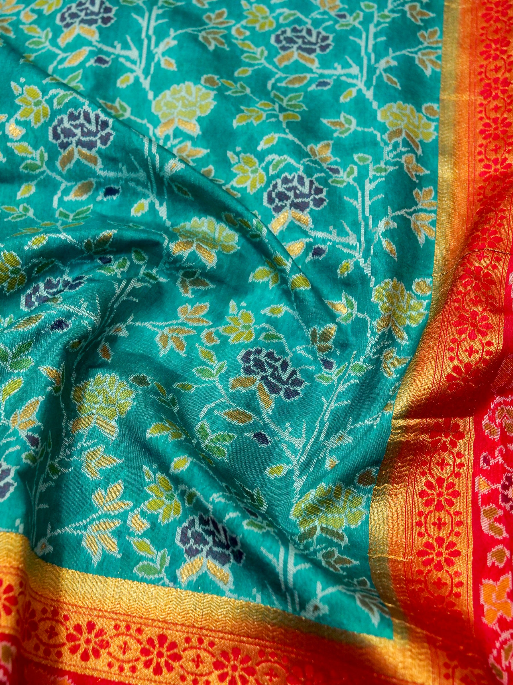 Sea Green Patola Silk Saree with Contrast Rani Pink Floral Zari Border