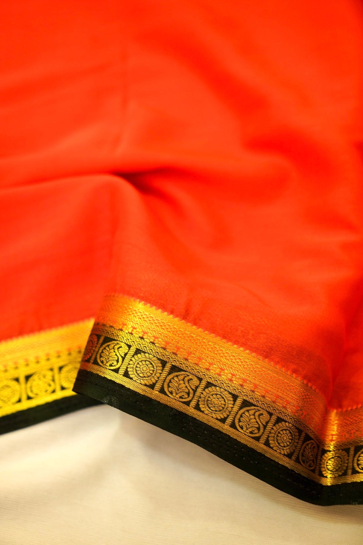 Maithili - Coral Red Mysore Crepe Silk Saree with Black Border