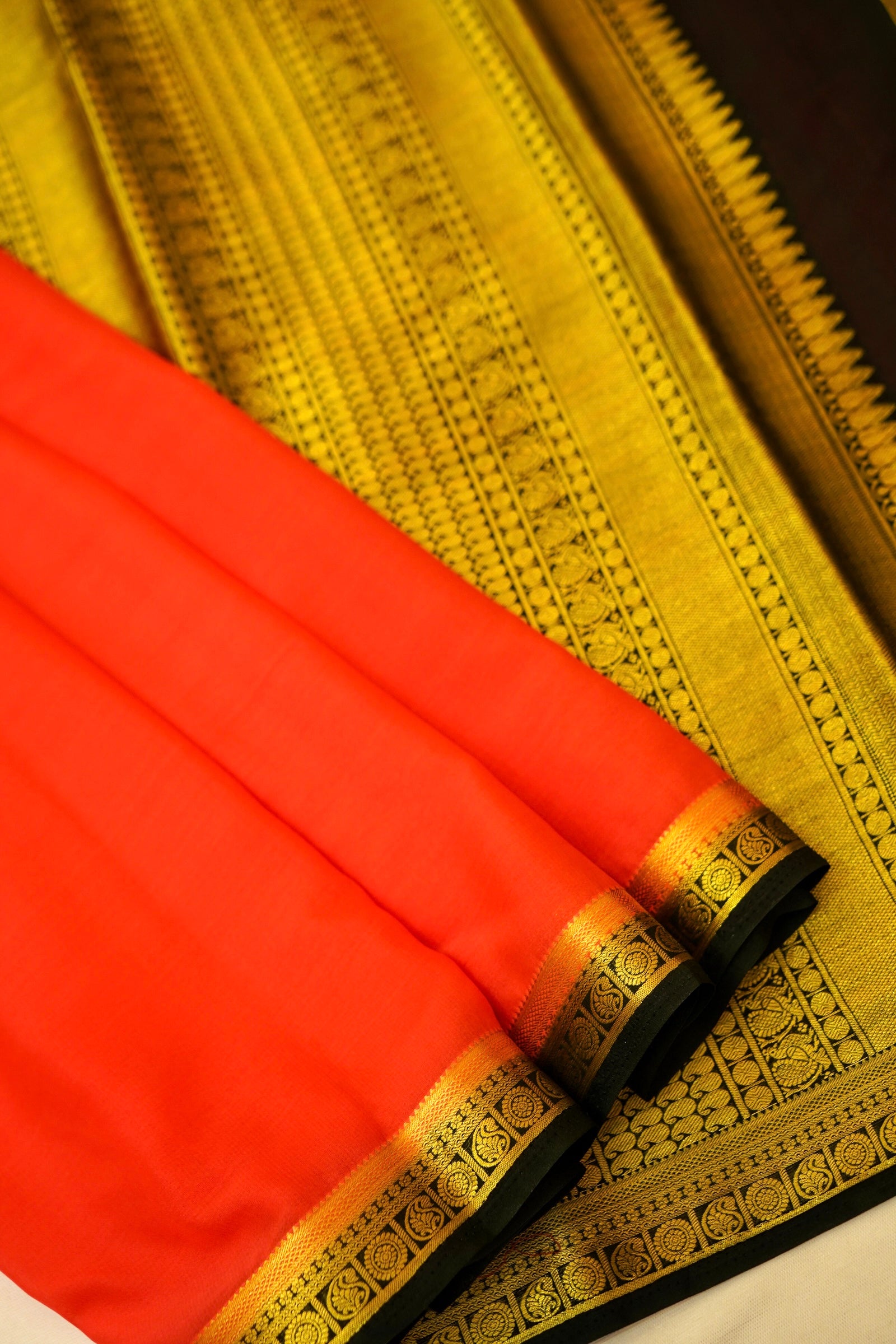 Maithili - Coral Red Mysore Crepe Silk Saree with Black Border