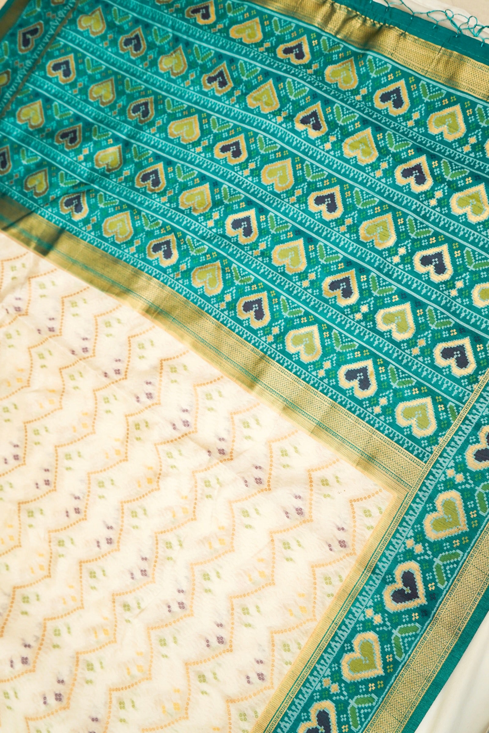 Ivory Ikkat Patola Silk Saree with Teal Border and Stitched Blouse