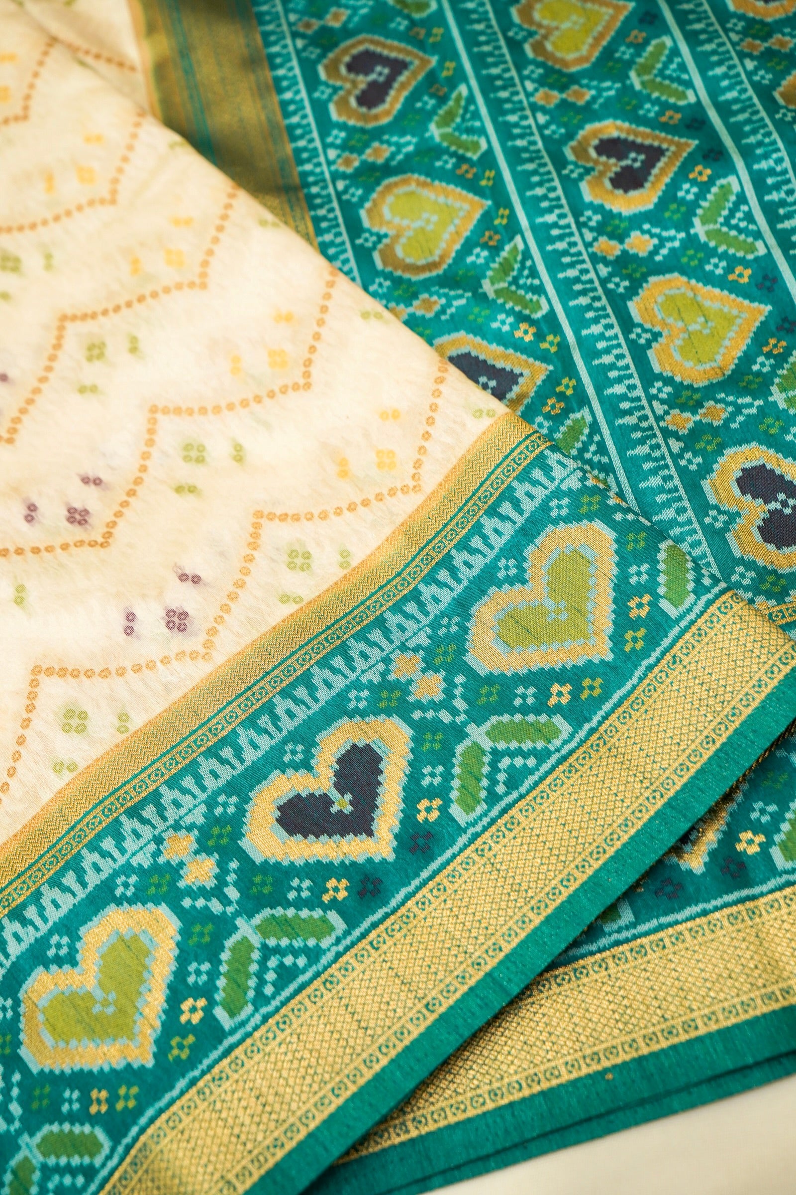 Ivory Ikkat Patola Silk Saree with Teal Border and Stitched Blouse