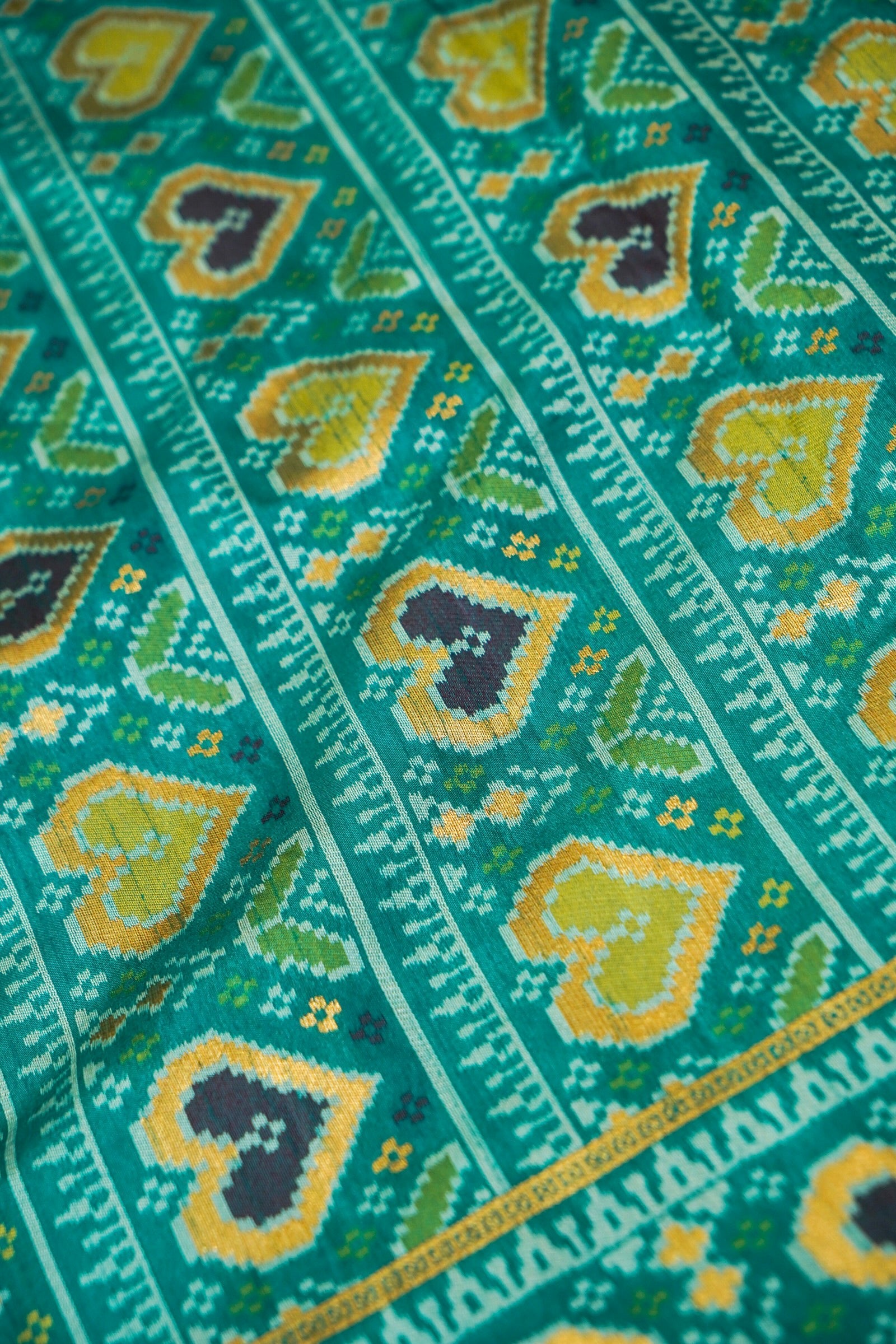 Ivory Ikkat Patola Silk Saree with Teal Border and Stitched Blouse