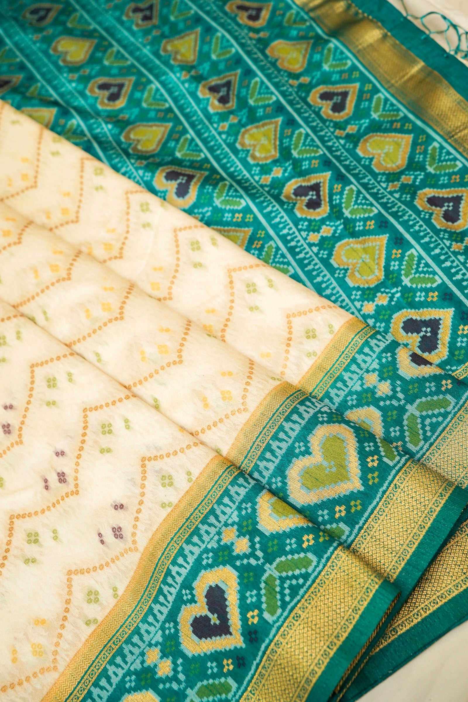 Ivory Ikkat Patola Silk Saree with Teal Border and Stitched Blouse