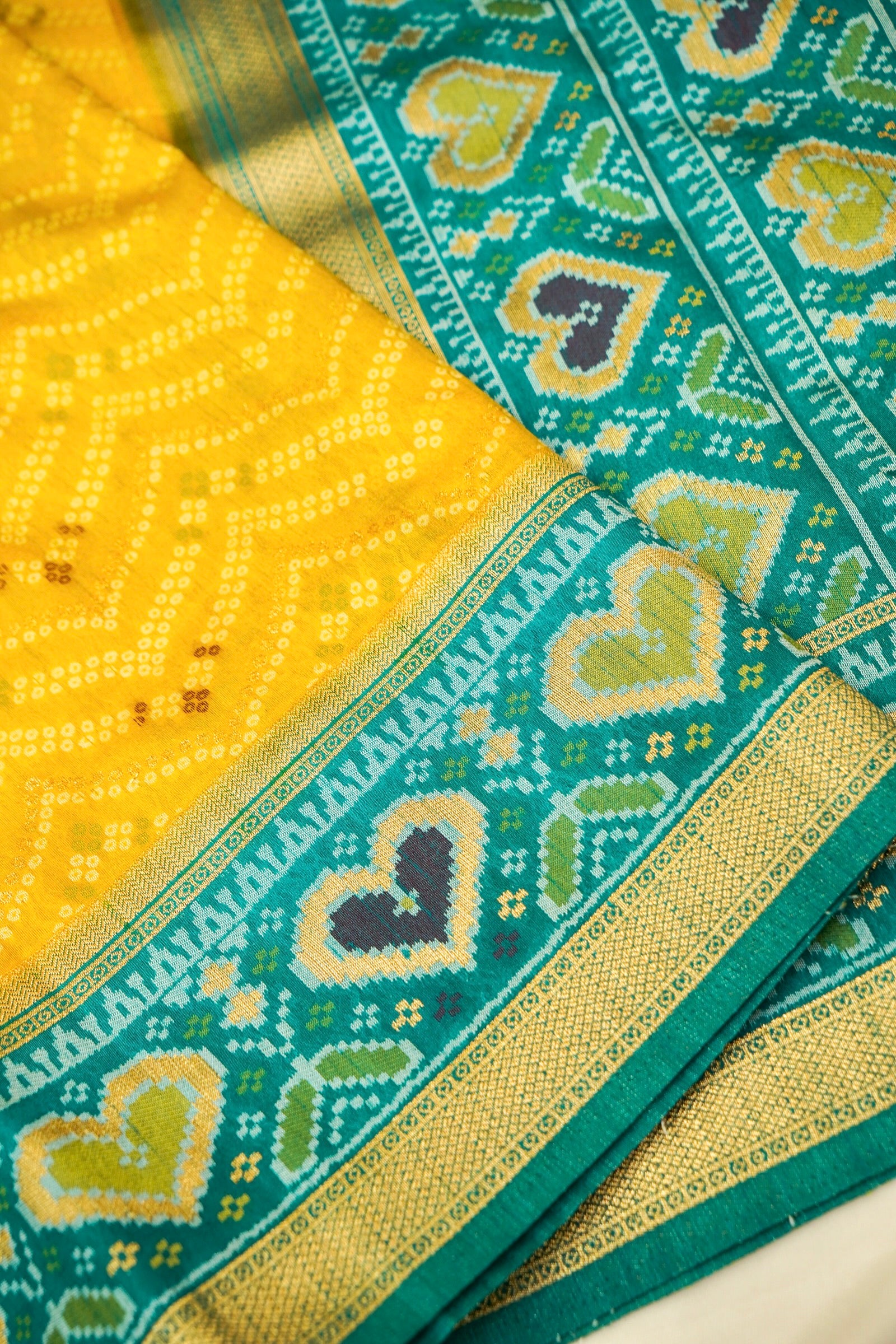 Mustard Yellow Ikkat Patola Silk Saree with Teal Border and Stitched Blouse