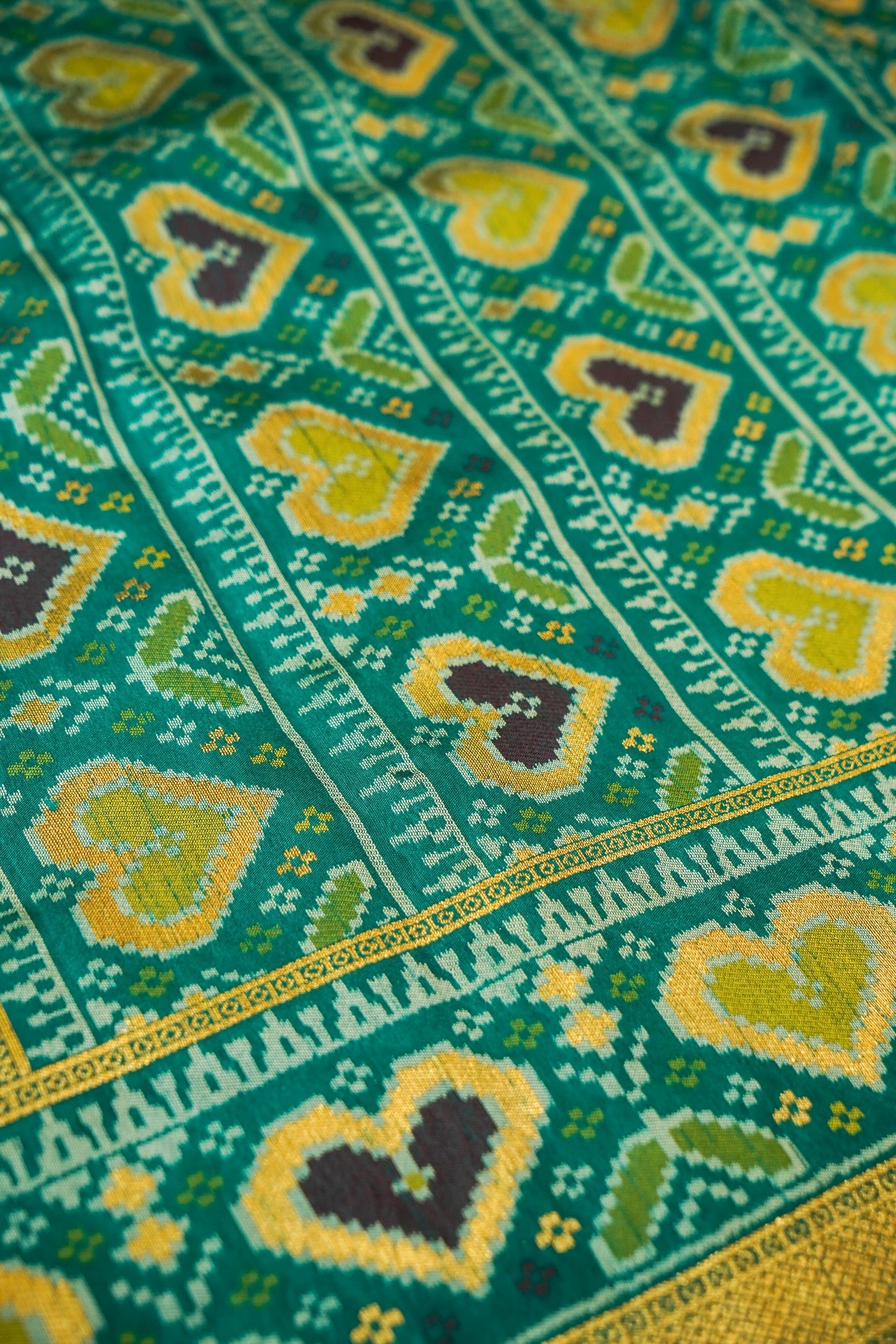Mustard Yellow Ikkat Patola Silk Saree with Teal Border and Stitched Blouse