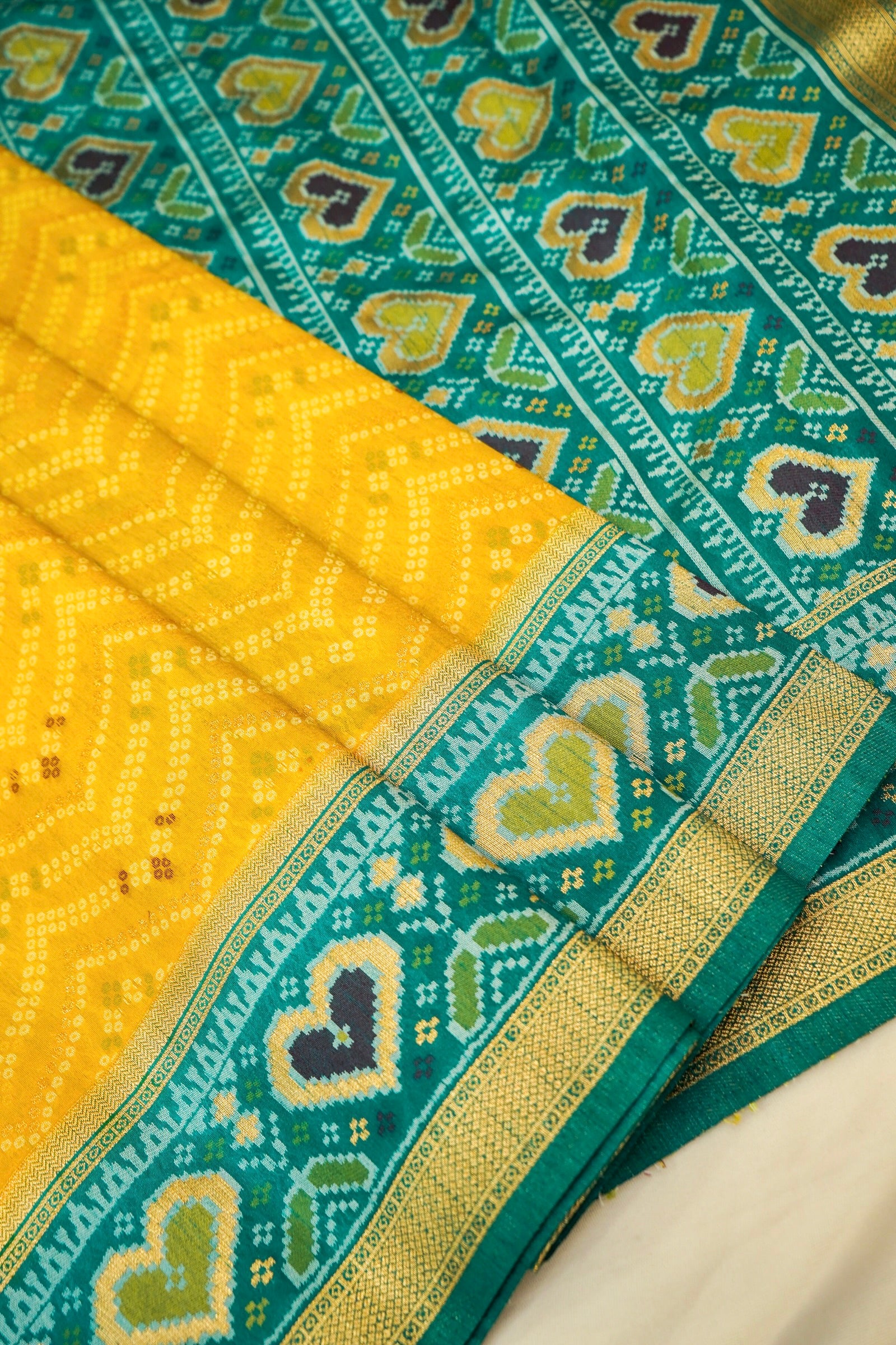 Mustard Yellow Ikkat Patola Silk Saree with Teal Border and Stitched Blouse