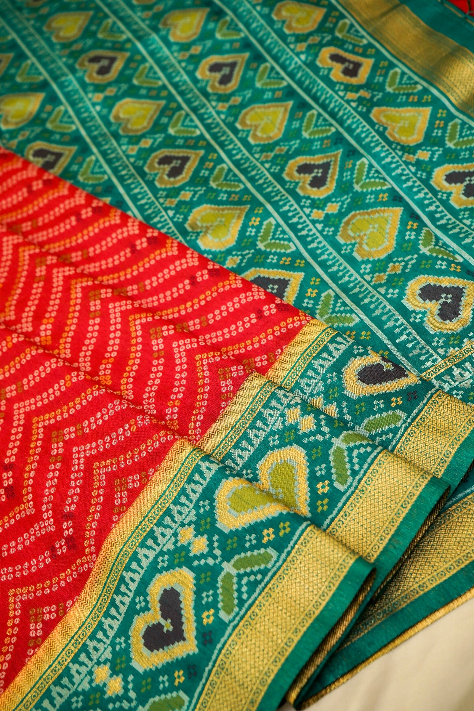 Bright Red Ikkat Patola Silk Saree with Teal Border and Stitched Blouse